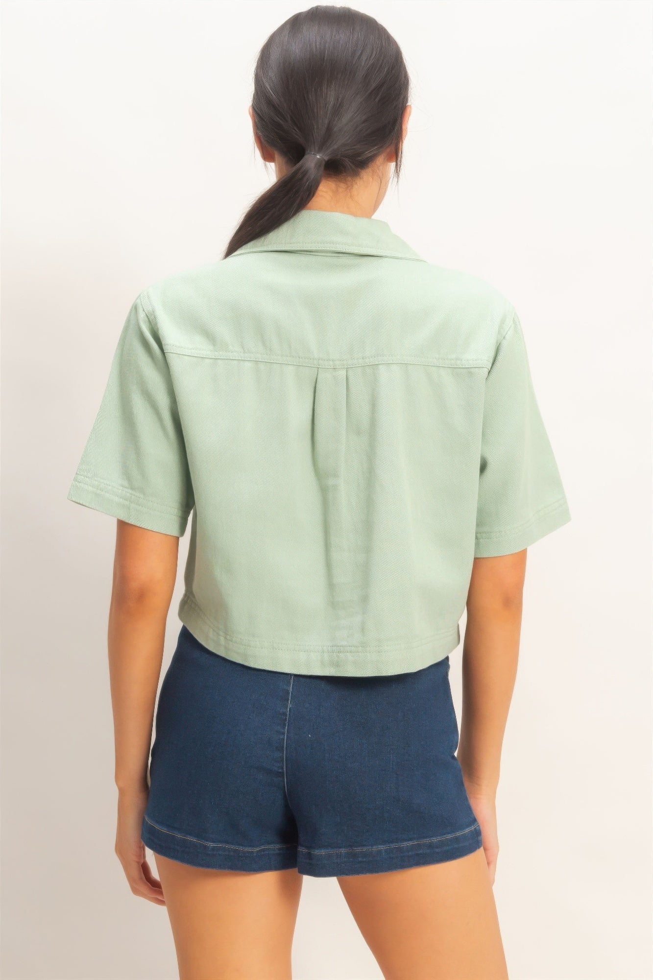 Back view of sage green collared V-neck top