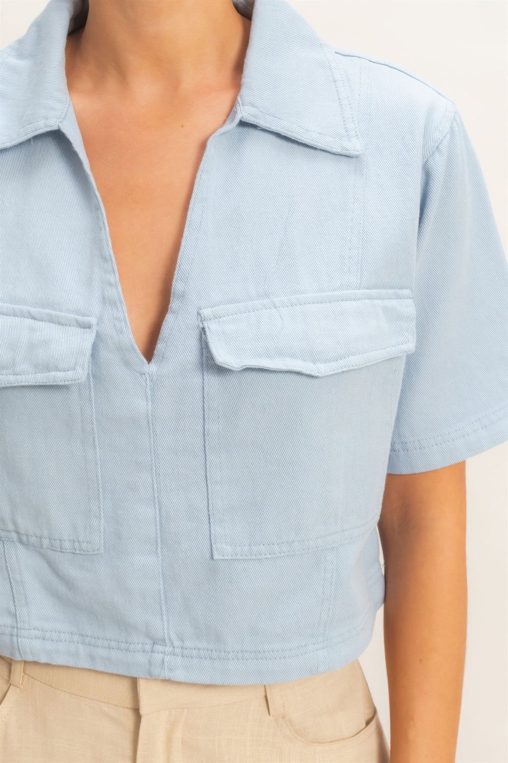 Collared V-neck top in light blue with chest flap pockets