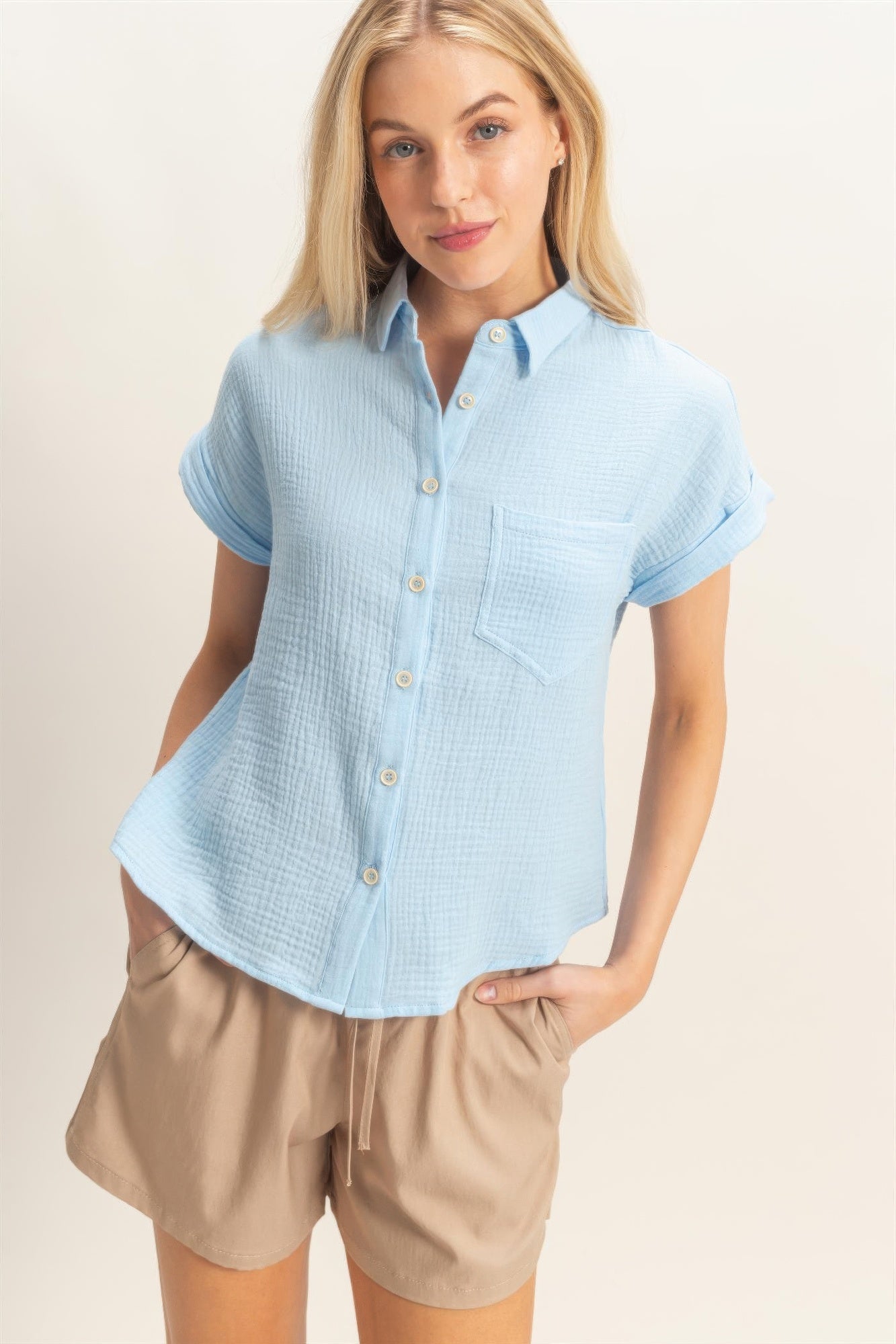 Rolled-sleeve button-up top in light blue with front button placket