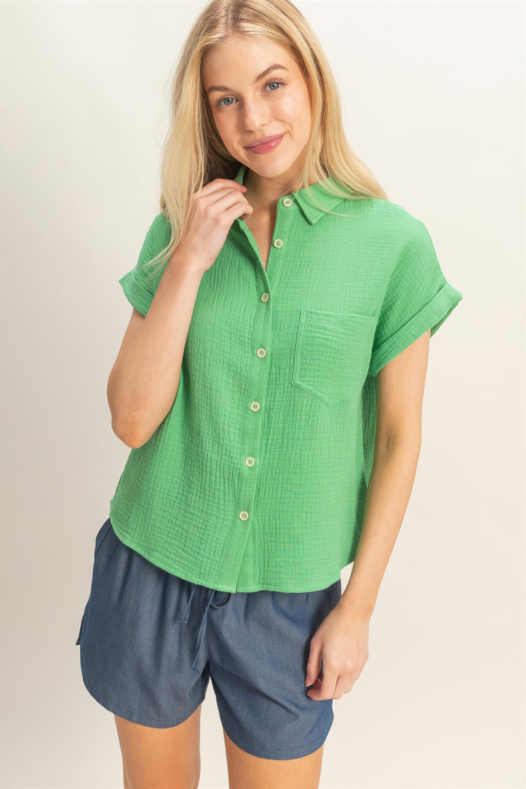 Green rolled-sleeve button-up top with front buttons and chest pocket