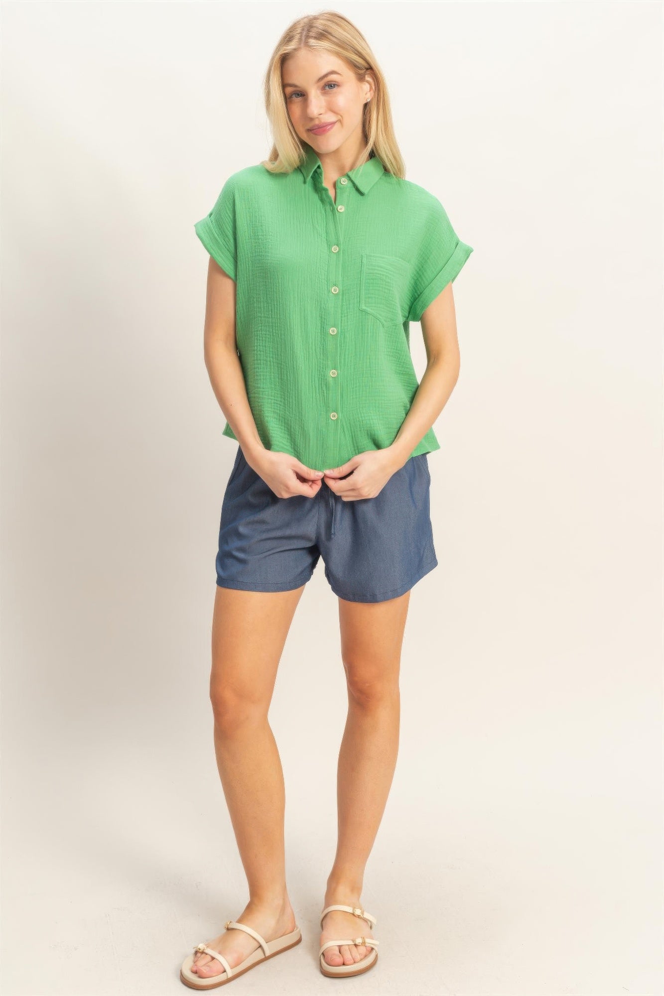 Rolled-sleeve button-up top in green, short sleeves and button placket