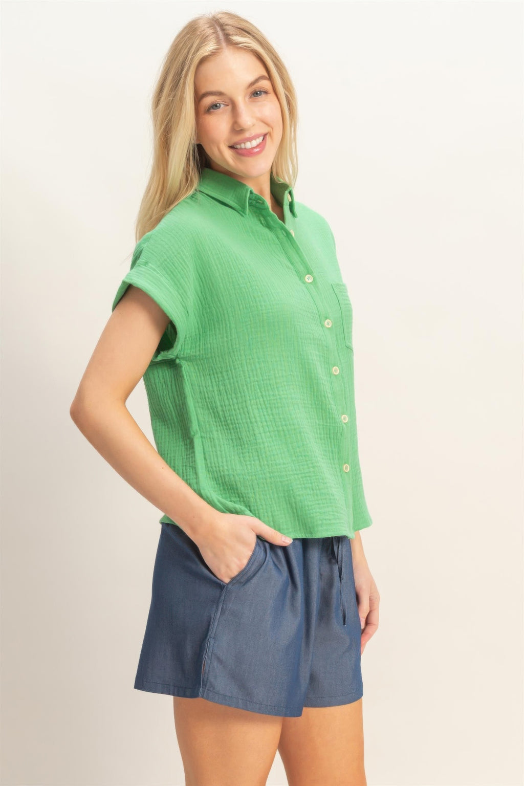 Green rolled-sleeve button-up top, front buttons and slightly curved hem
