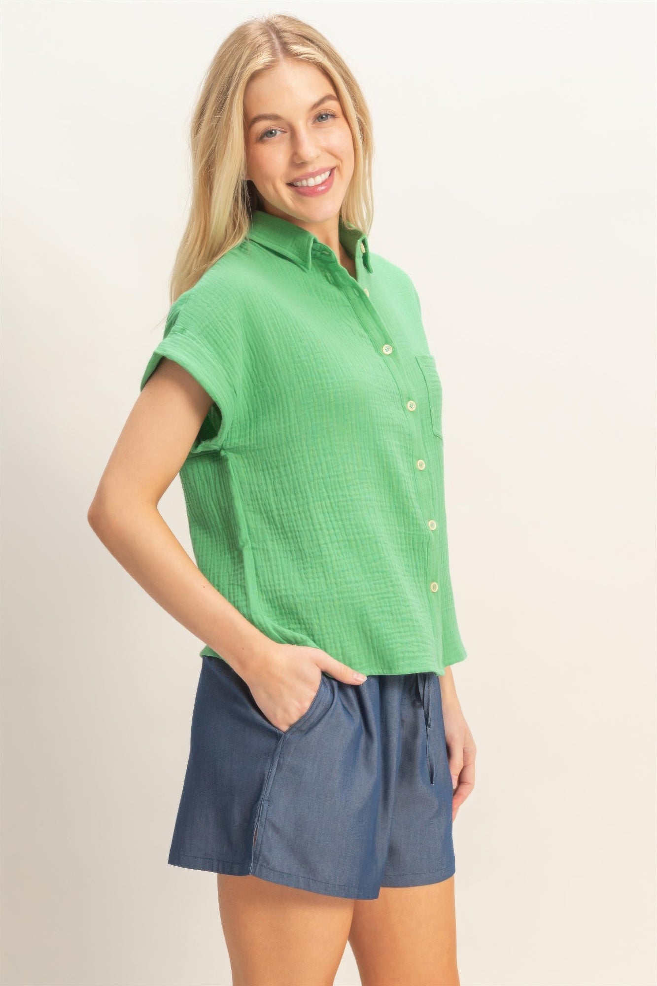 Green rolled-sleeve button-up top, front buttons and slightly curved hem