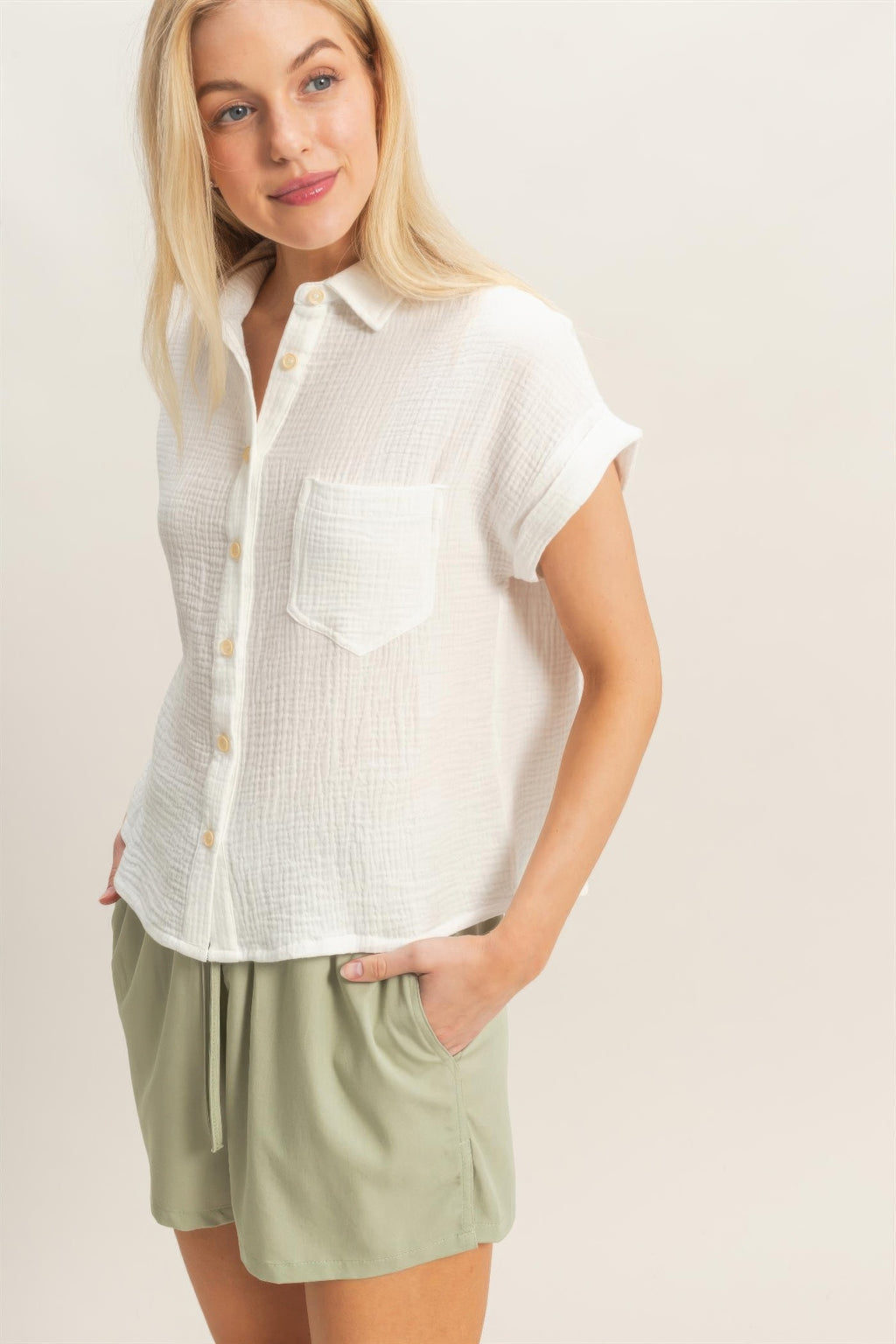 Off-white button-up blouse close-up of chest pocket and button placket