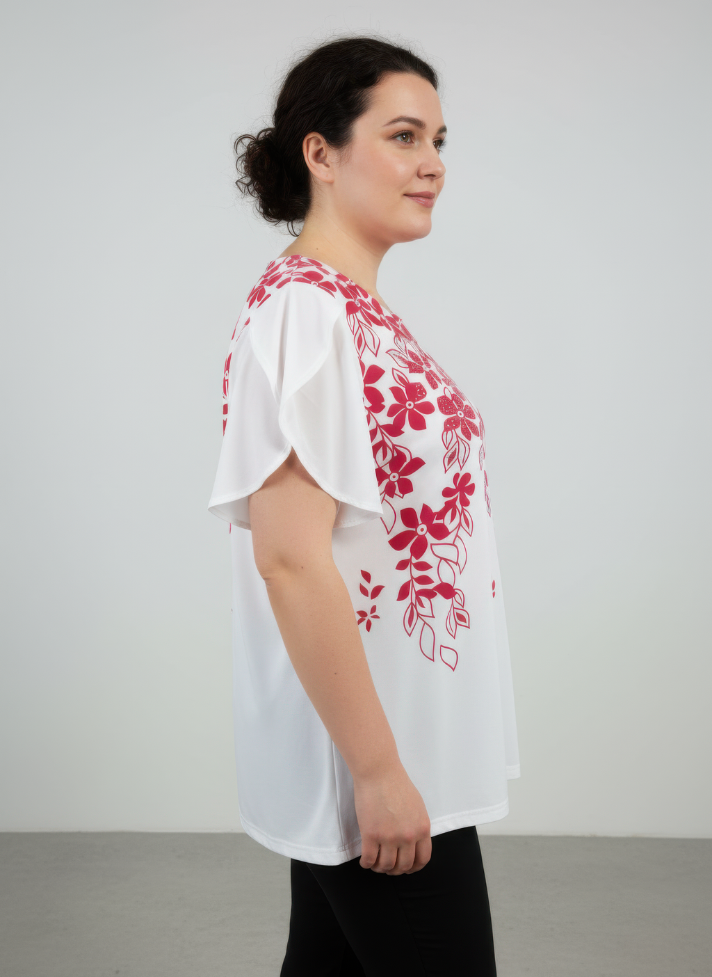 Red floral knit top with flutter sleeves; side view of botanical print on white base