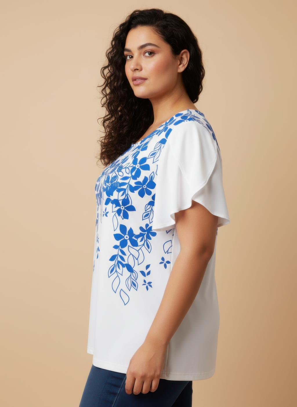 Blue floral knit top with flutter sleeves; side view of all-over print on white base