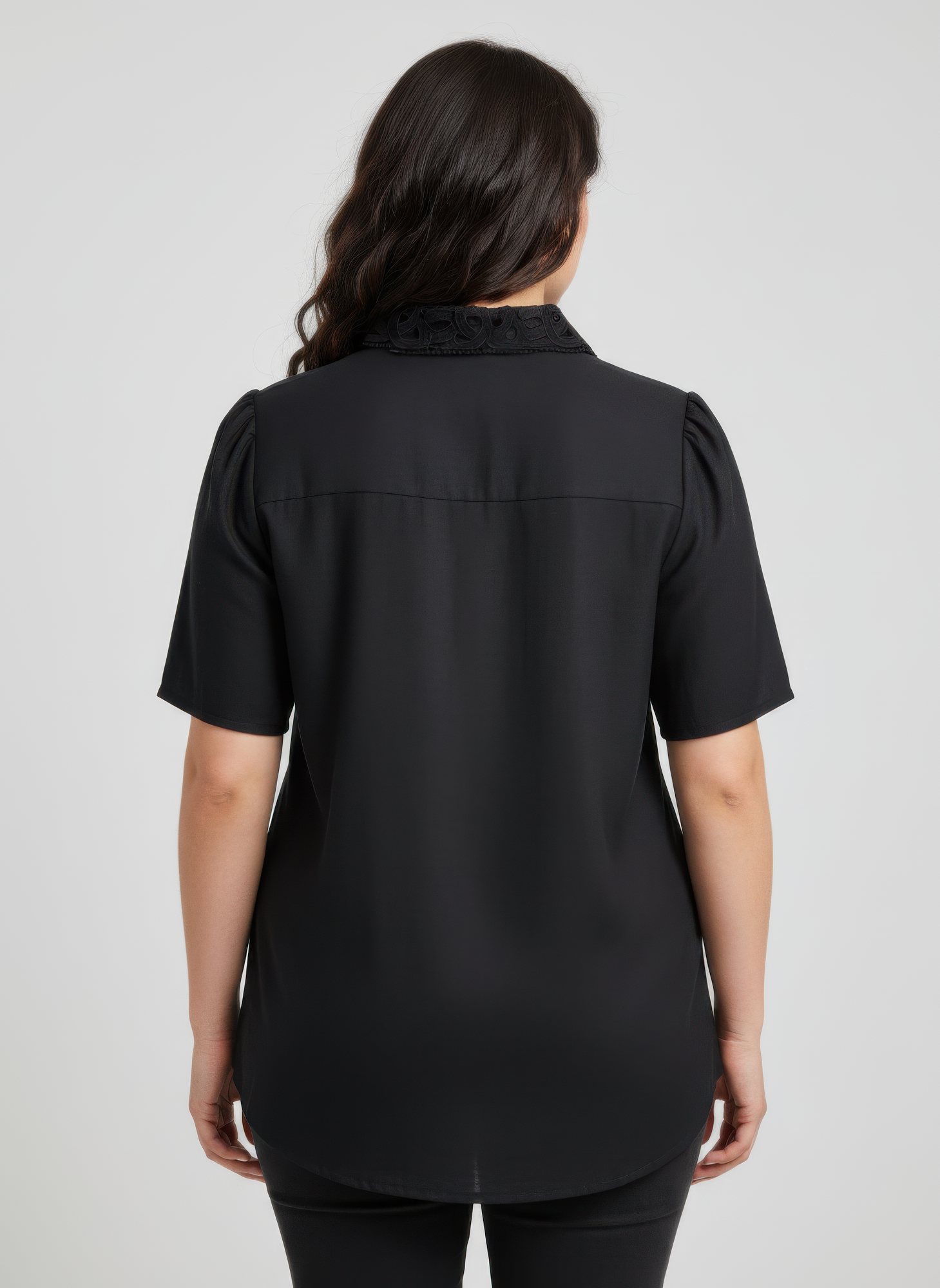 Back view: dark lace-trim button-front collared blouse with short sleeves