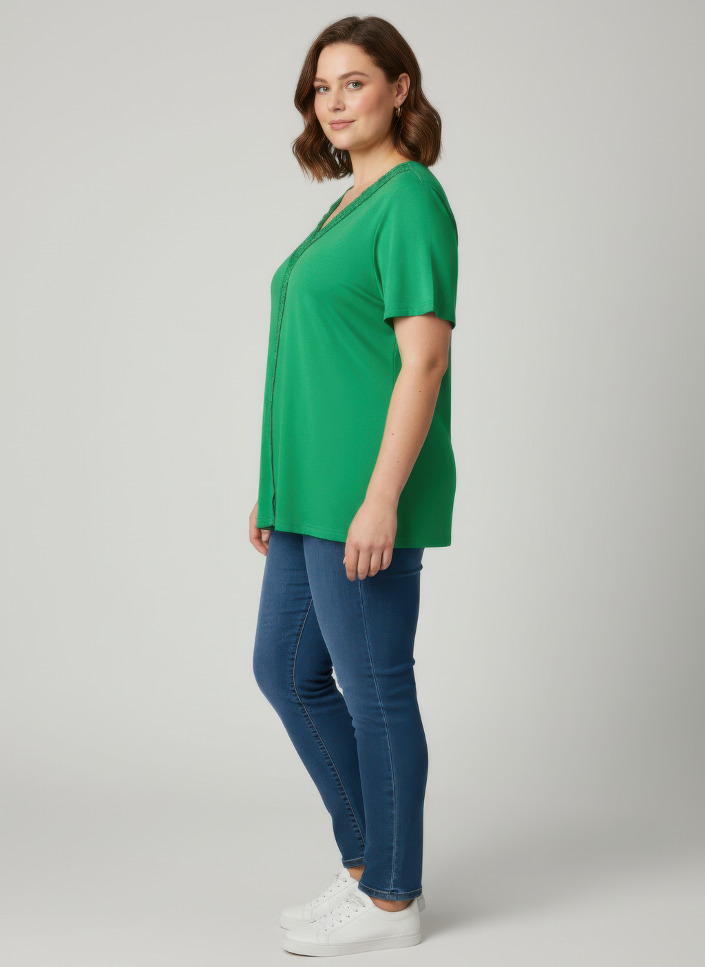 Green short sleeve knit top with lace V-neck trim, side view