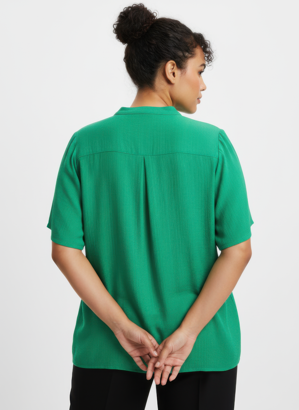 Green knit utility top, back view with center seam and split hem detail