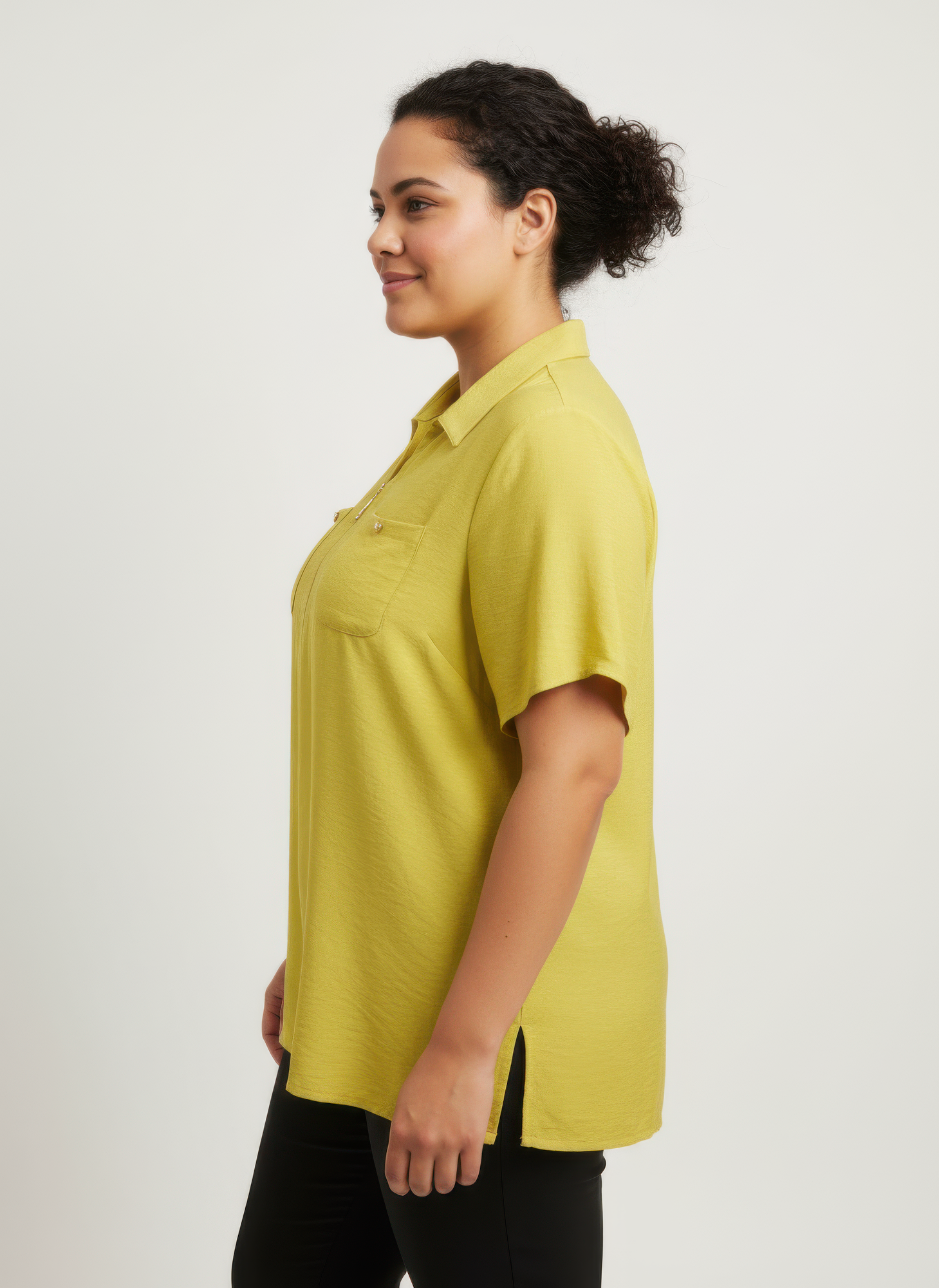 Lime utility knit top, side view: zip-front placket and chest pockets, short sleeves