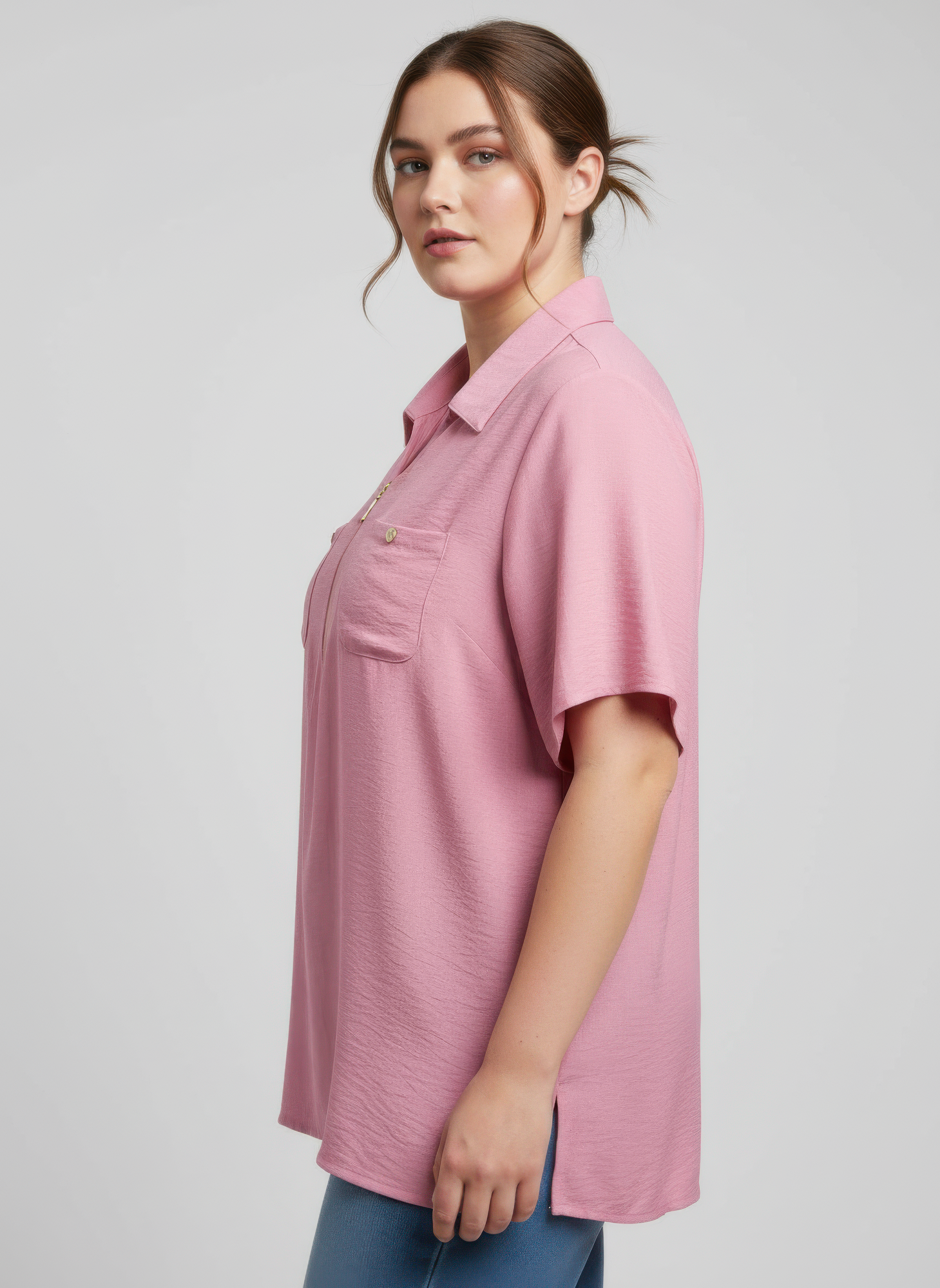 Pink utility knit top, side view: zip-front and chest pocket details, short sleeves