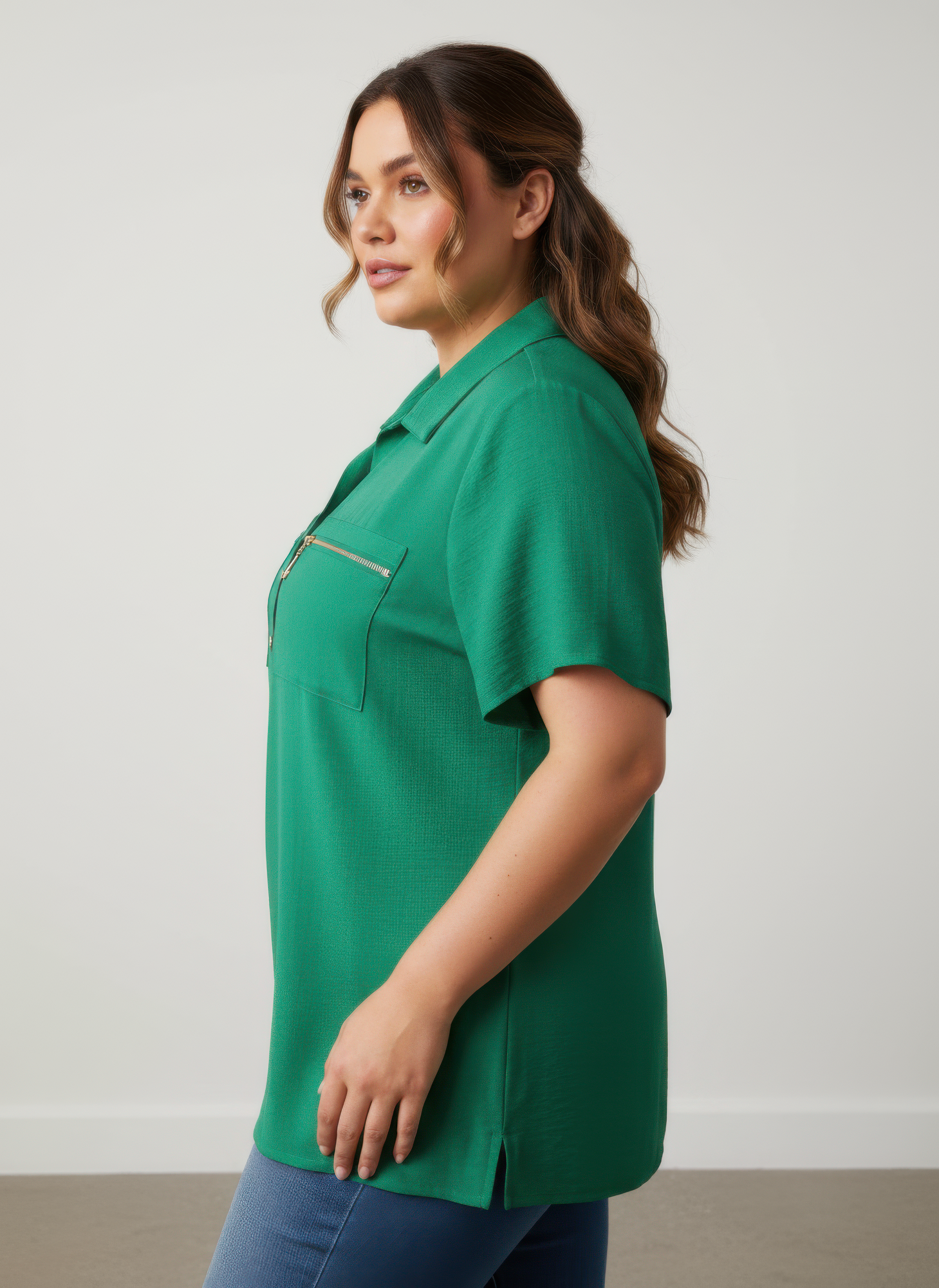 Green knit tunic top side view with chest zip pocket and collared neckline