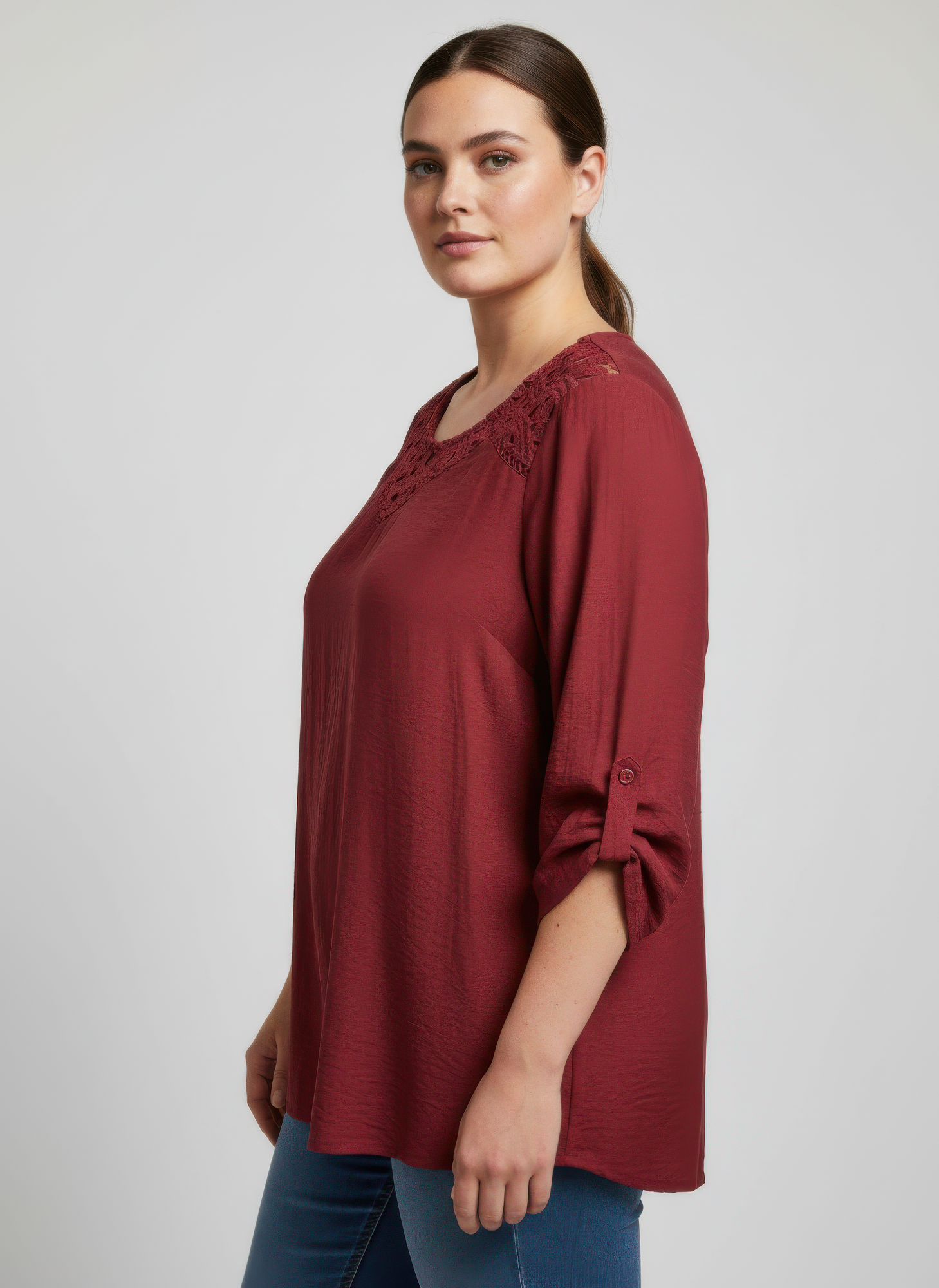 Burgundy lace yoke knit tunic, side view with cutout lace neckline