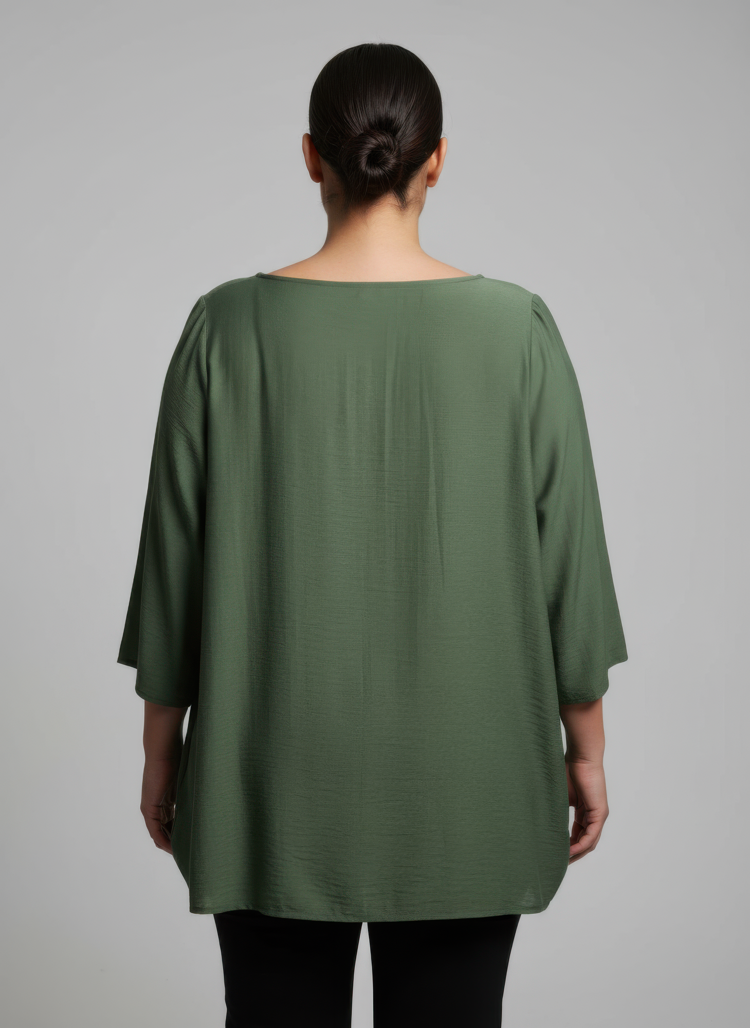 Green lace yoke knit tunic, back view with draped loose shoulders