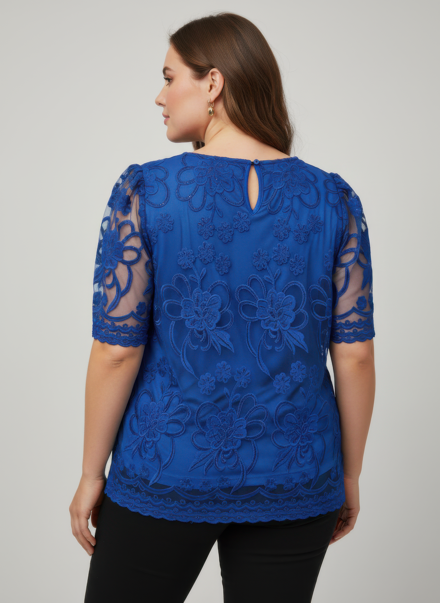 Back view of blue embroidered lace overlay top with keyhole neckline detail