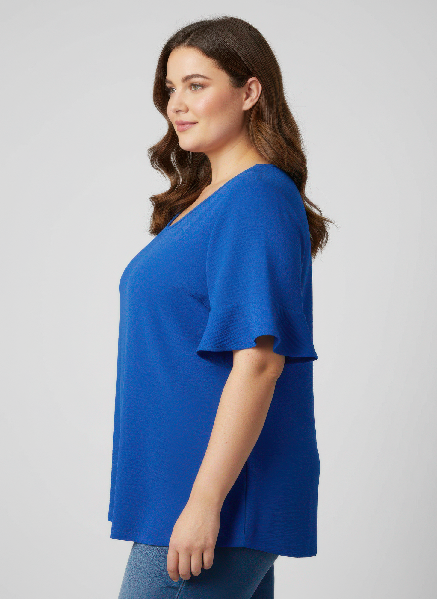 Blue textured top with short ruffle sleeves and V-neck, side view