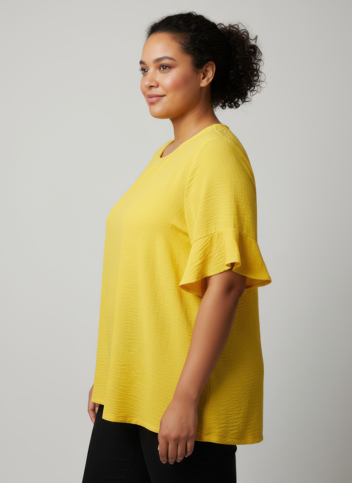 Yellow textured short sleeve top with flared ruffle sleeves