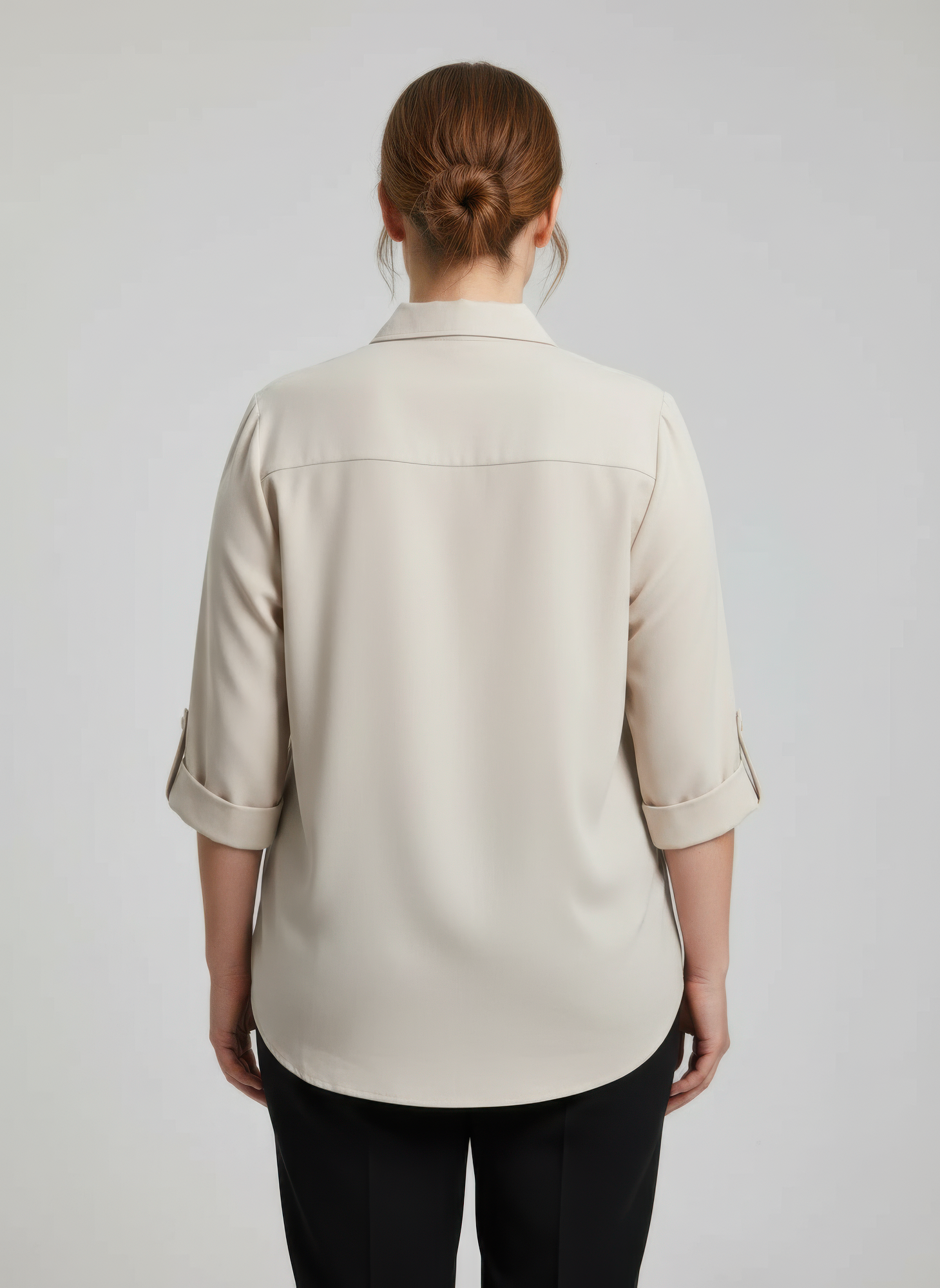 Back view of beige zip-front utility pocket tunic blouse with 3/4-length sleeves