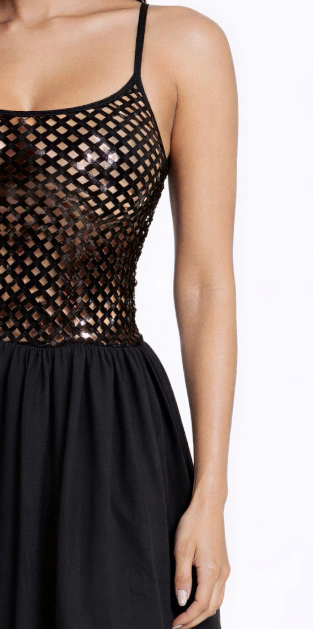 Close-up: netted sequin bodice with spaghetti straps and black gathered waist skirt