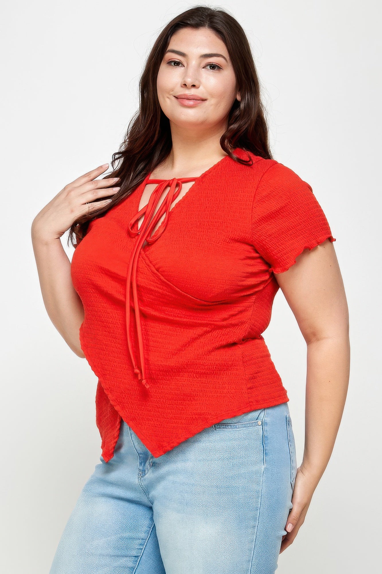 Red textured wrap top with tie-neck strings, asymmetrical hem, short sleeves