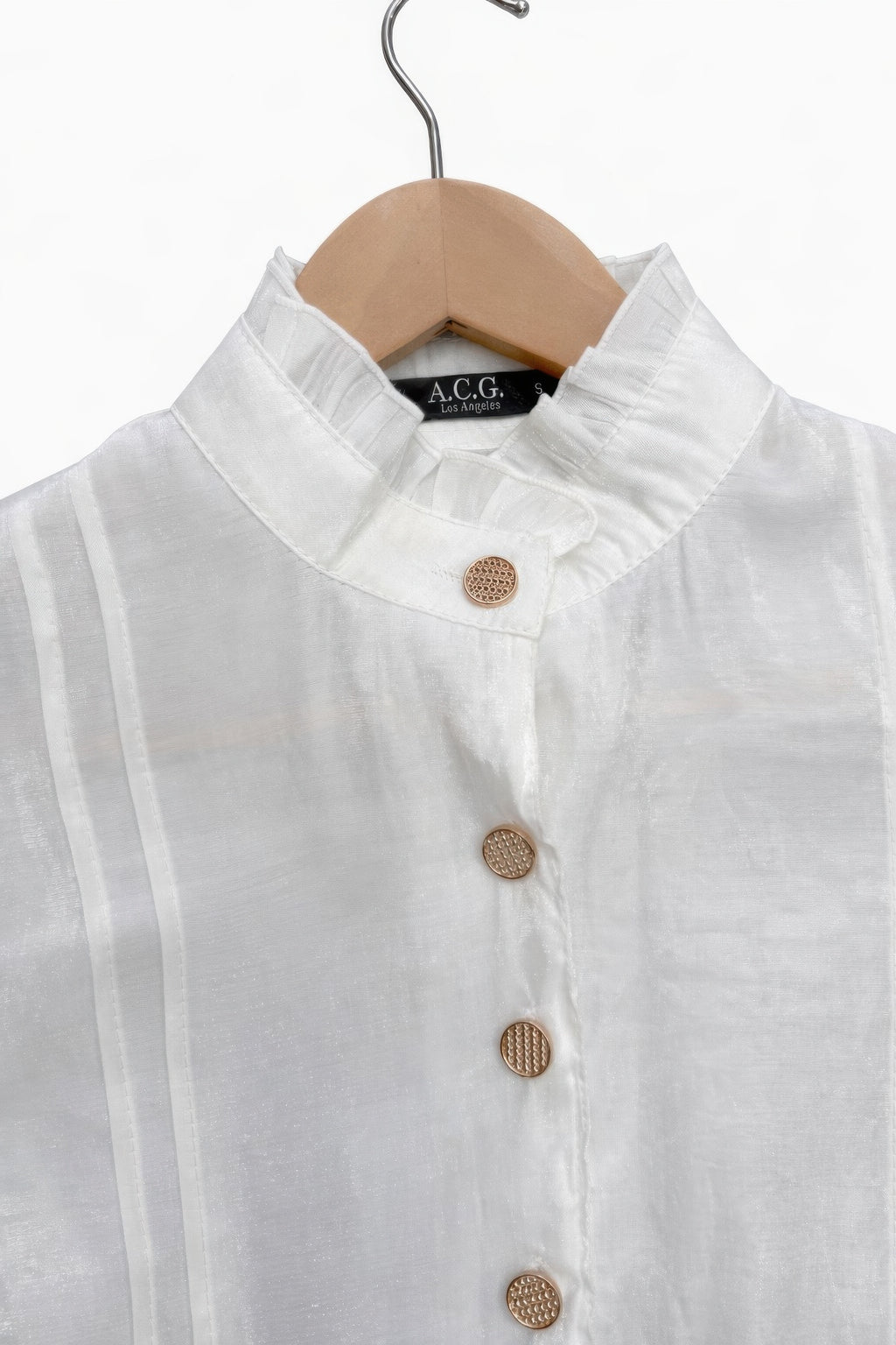 Close-up of white satin Victorian top: stand collar and round textured buttons, button placket