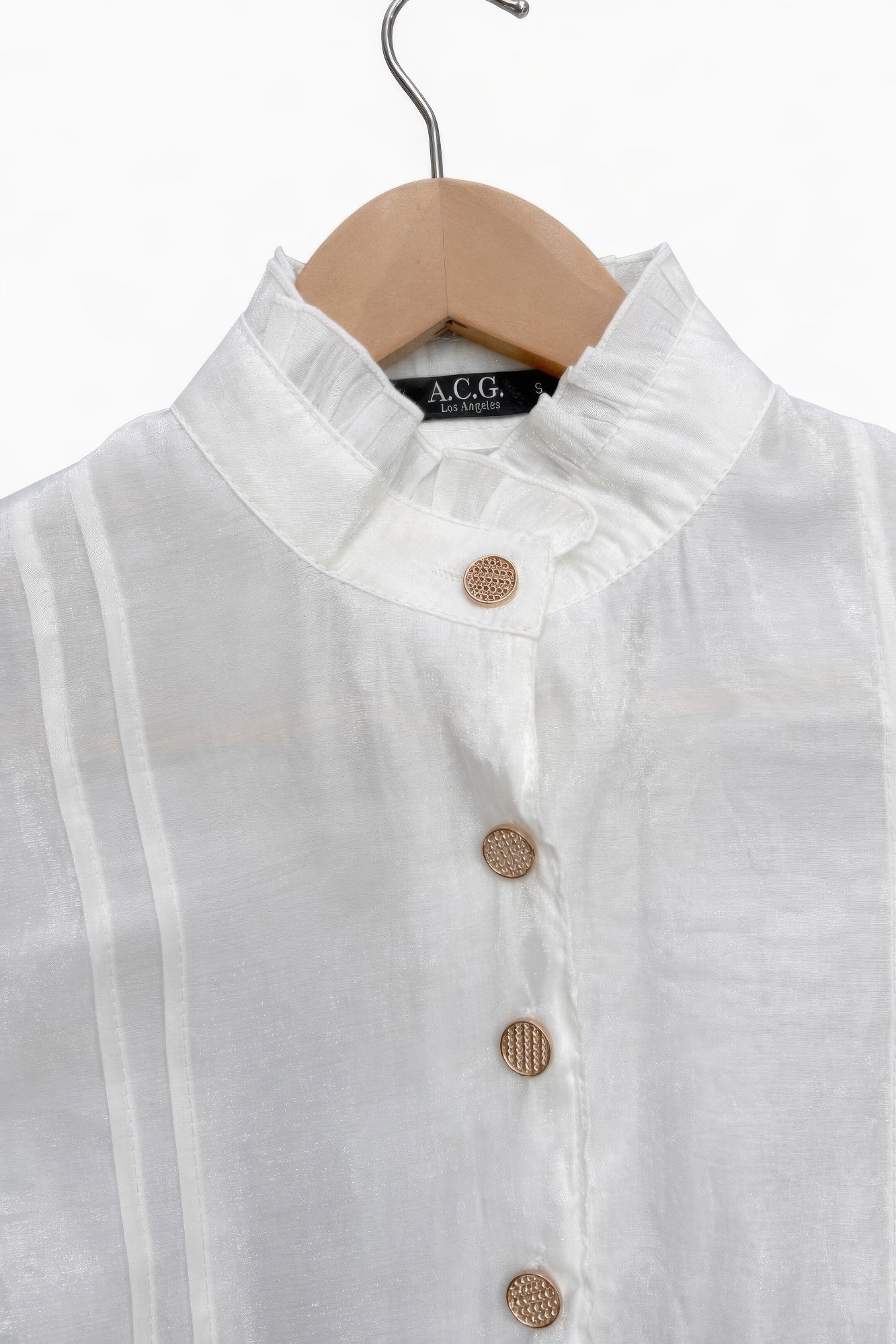Close-up of white satin Victorian top: stand collar and round textured buttons, button placket