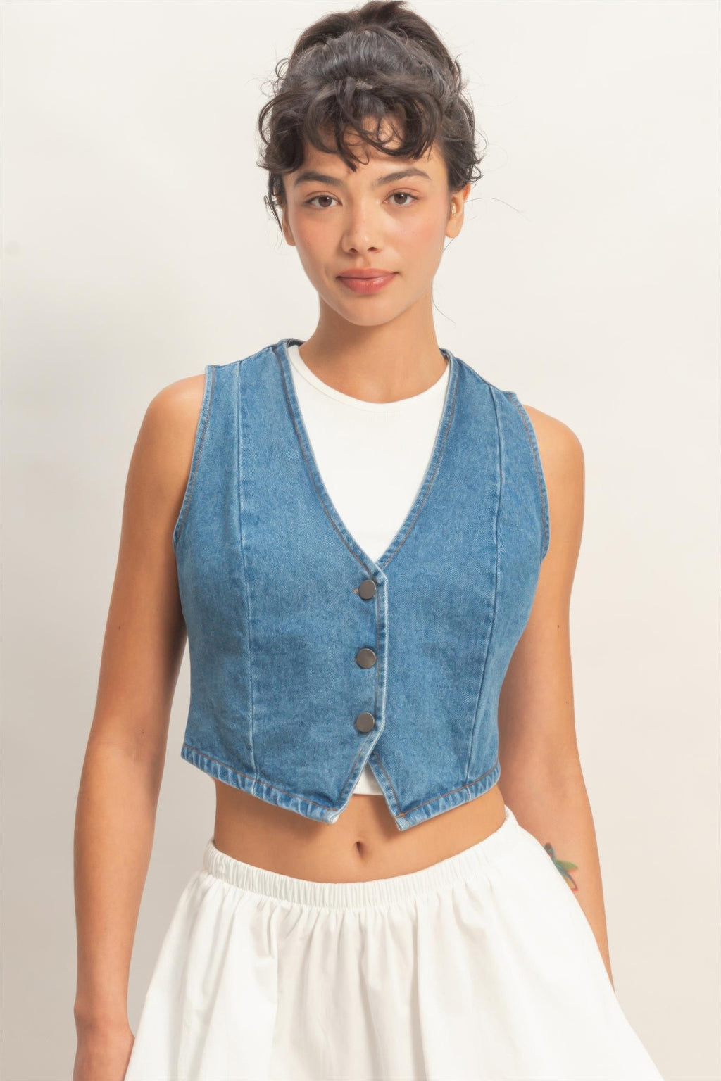 Light blue V-neck sleeveless denim vest with three-button front, straight cut