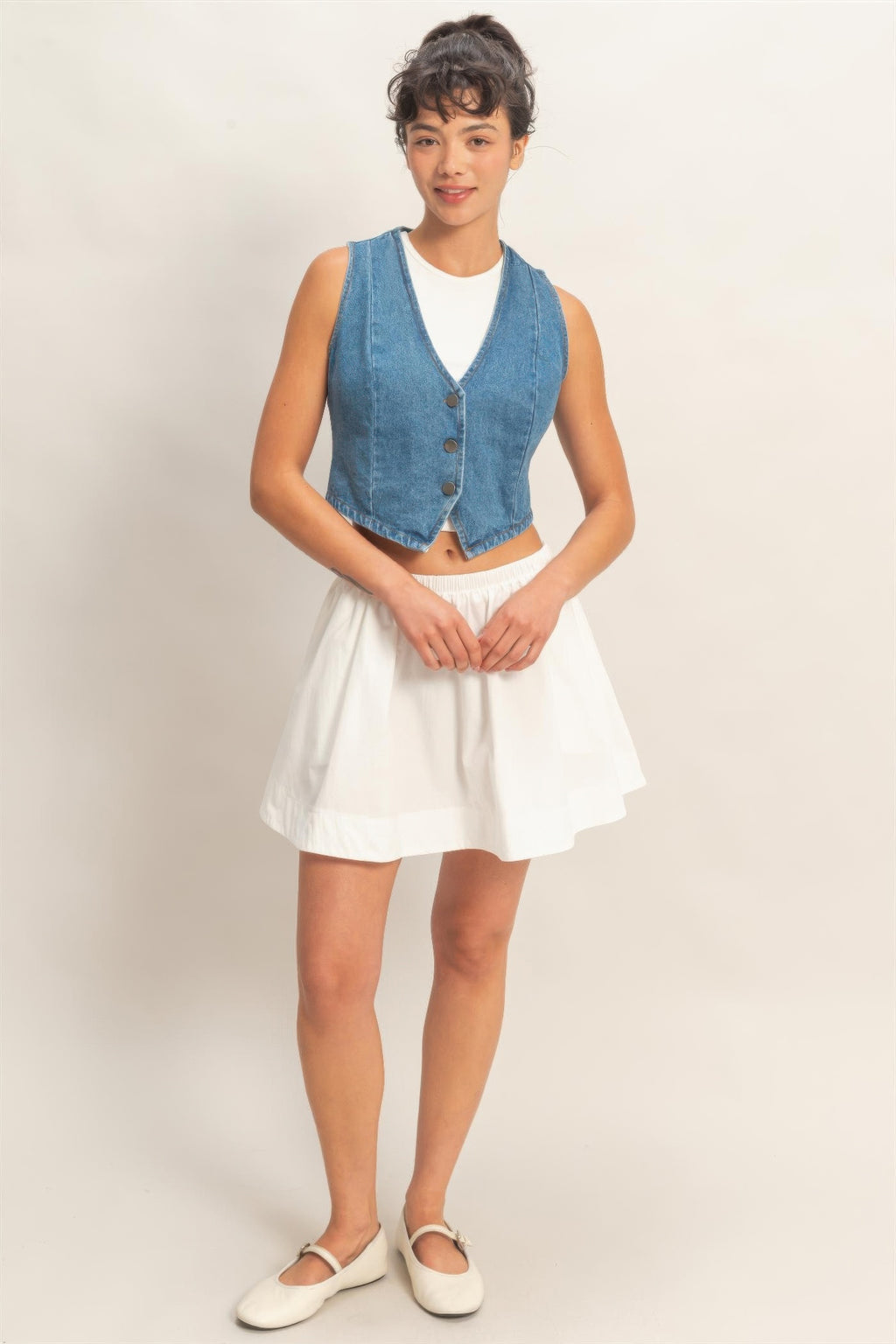 Light blue sleeveless denim vest with V-neck and button placket