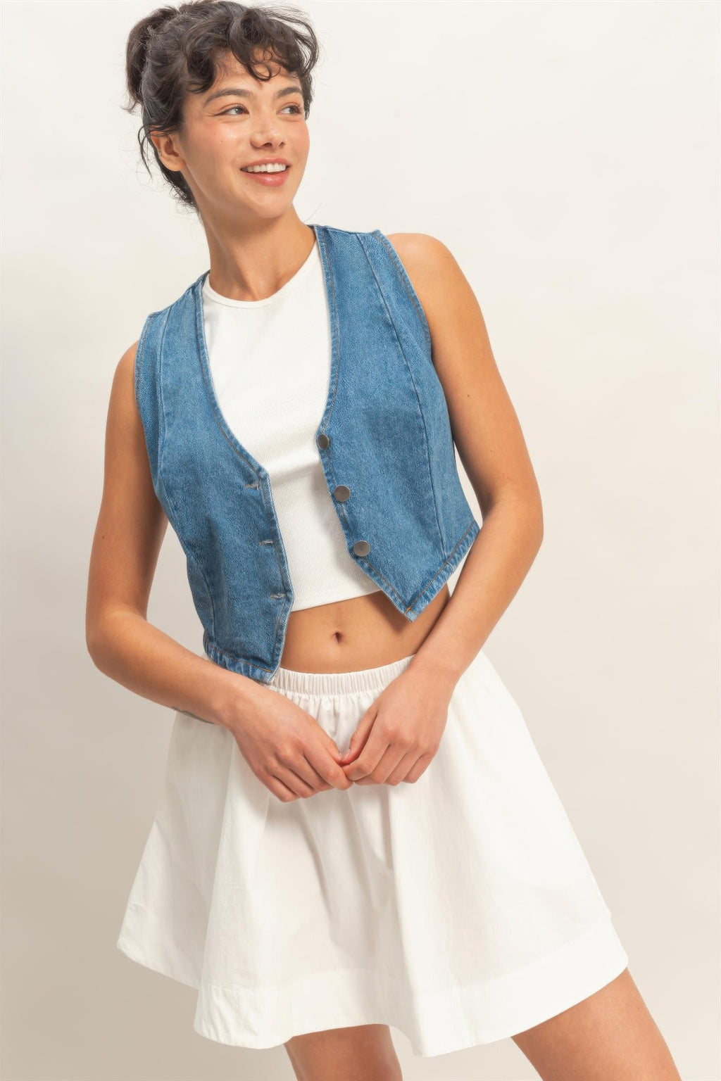 Light blue V-neck denim vest with button front and angled side seam