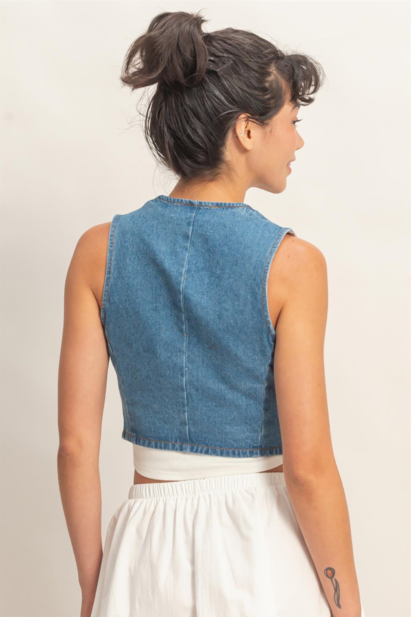 V-neck denim sleeveless vest, light blue, back view with center seam