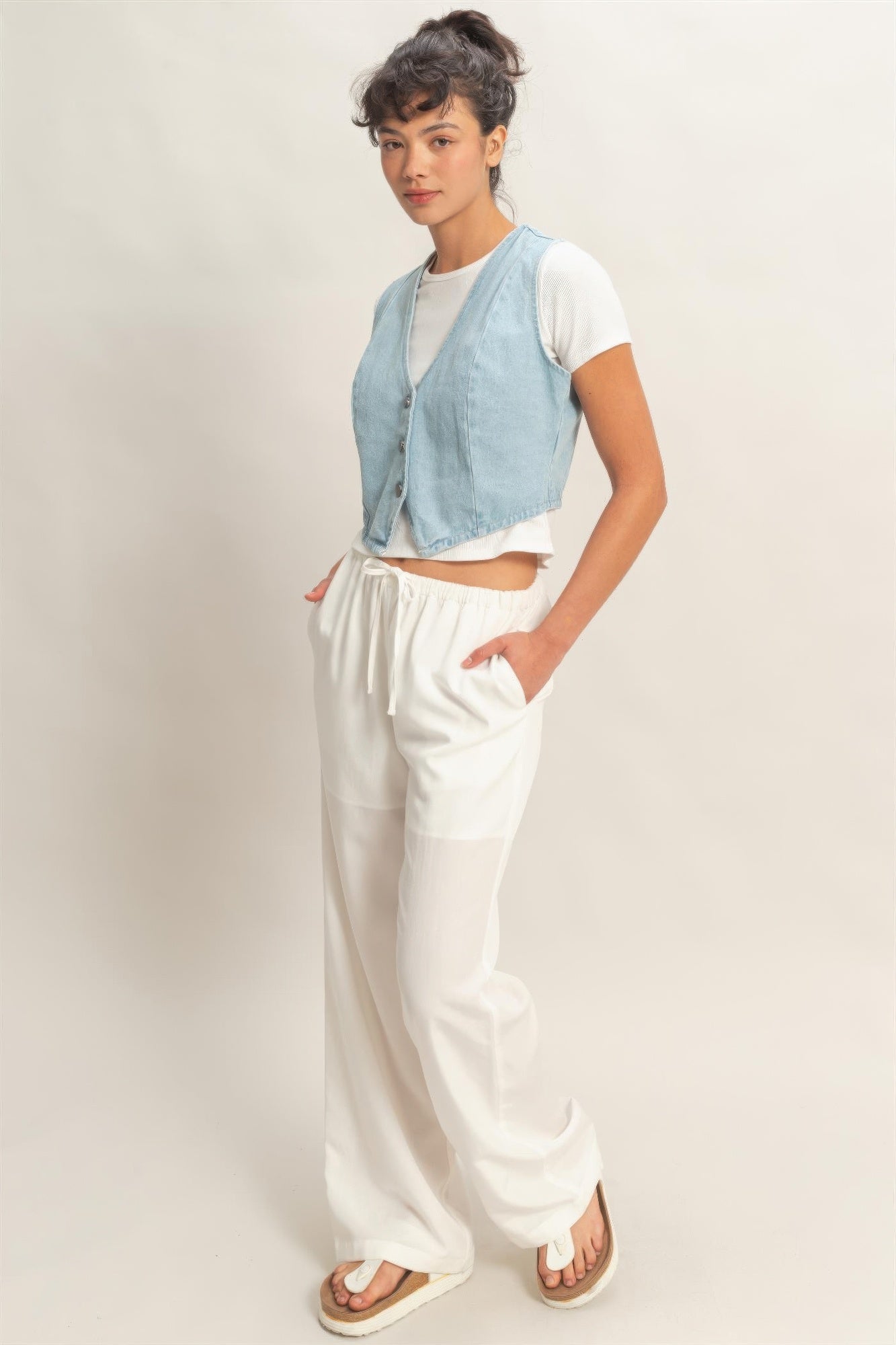 Light blue denim vest, V-neck sleeveless style with button-down front