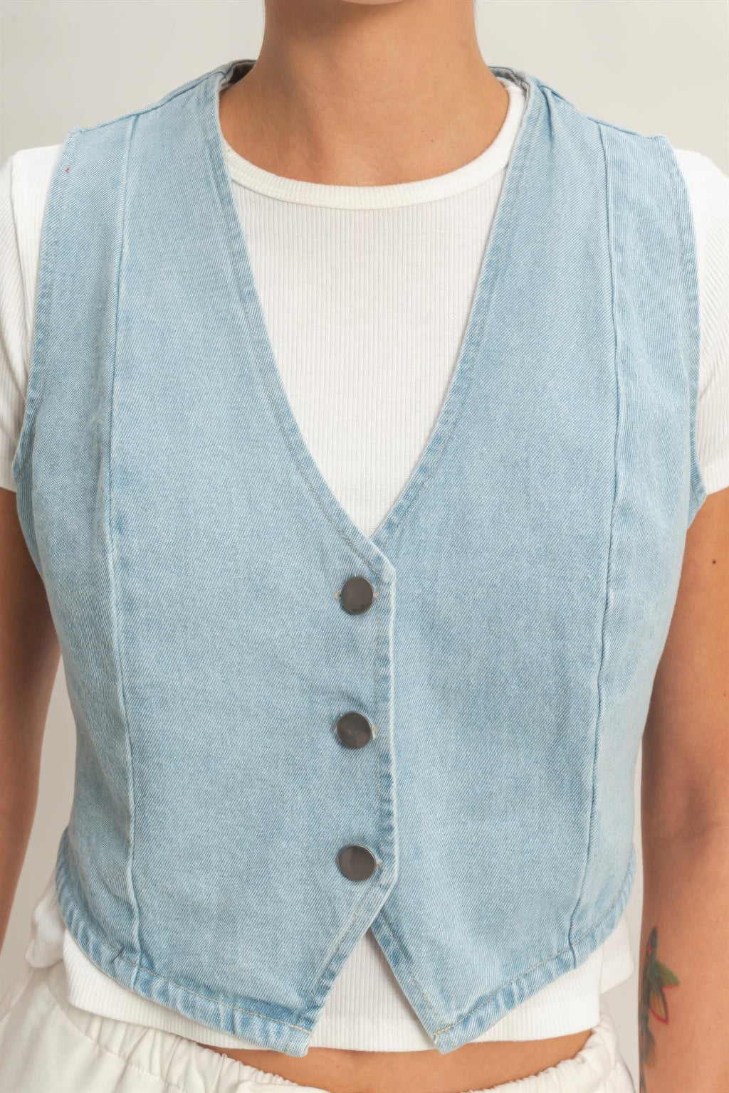 Denim vest V-neck with three dark buttons and contrast topstitching