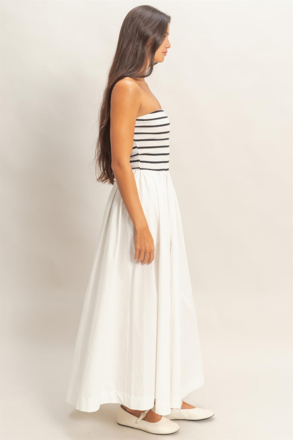 Side view striped strapless midi dress with smocked bodice and flowy tiered skirt