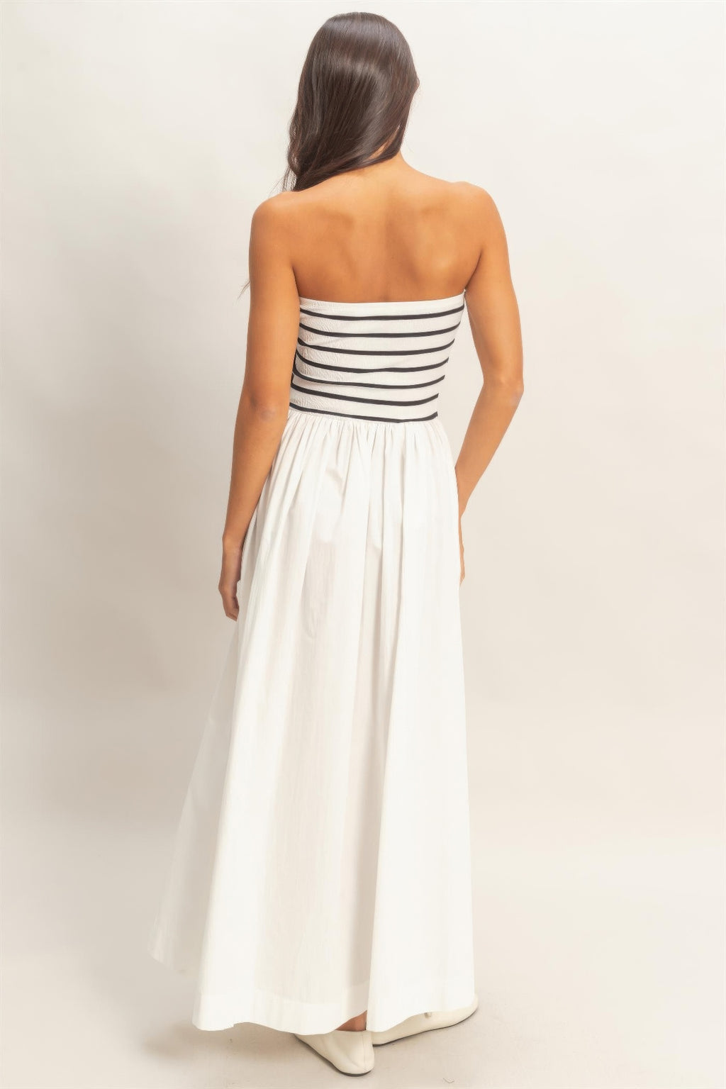 Back view striped strapless flowy midi dress with pleated skirt