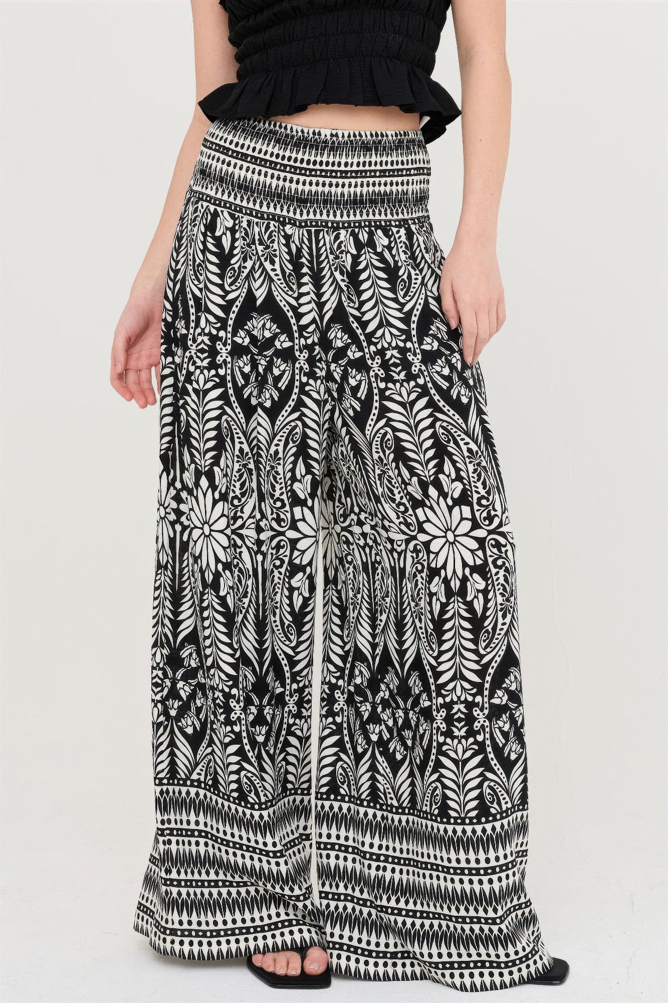 Smocked waist floral pants, black with white leafy botanical print