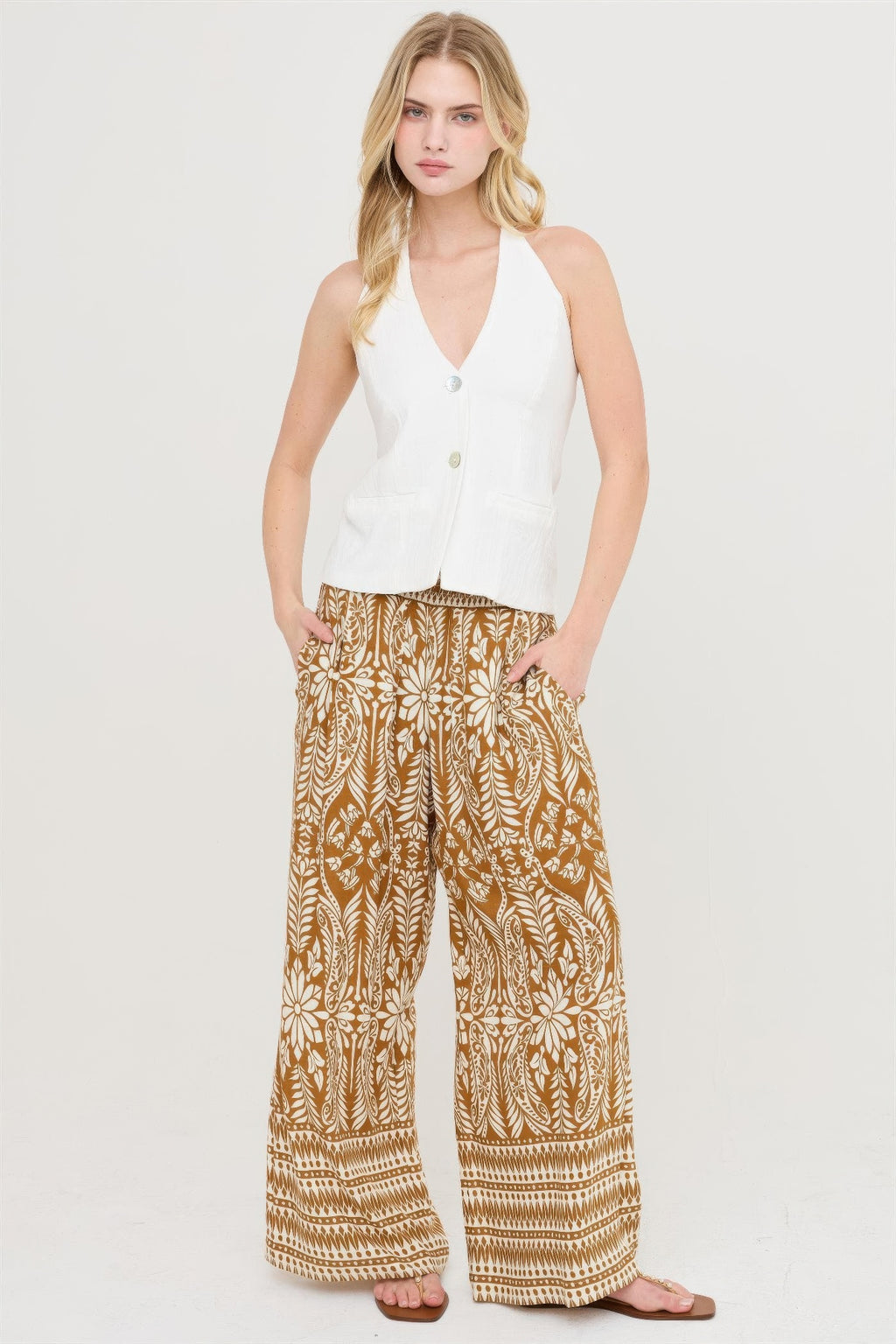 Brown smocked waist floral wide-leg pants with border stripe detailing at cuffs