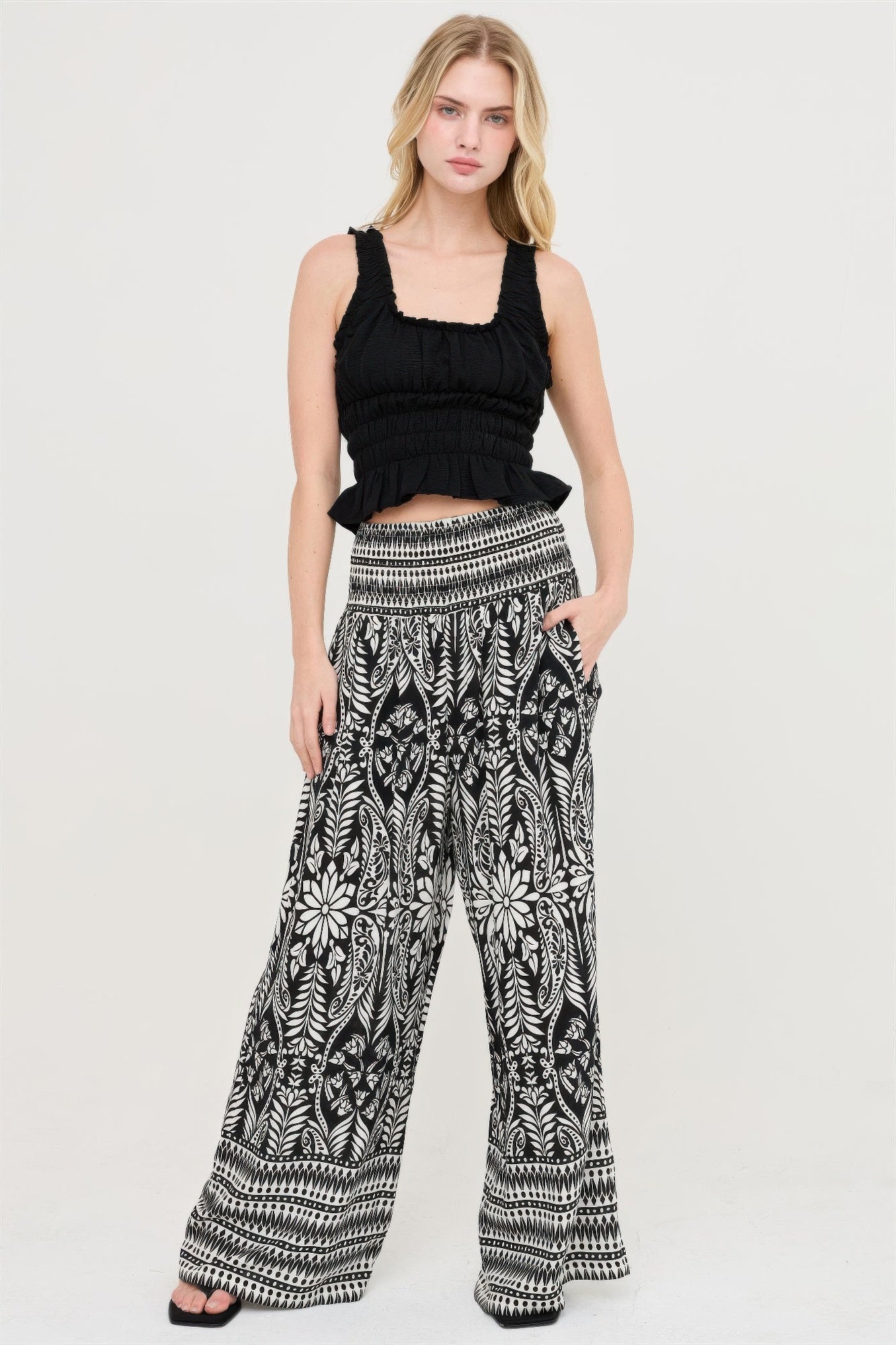 Smocked waist floral pants with wide-leg drape in black-and-white botanical print
