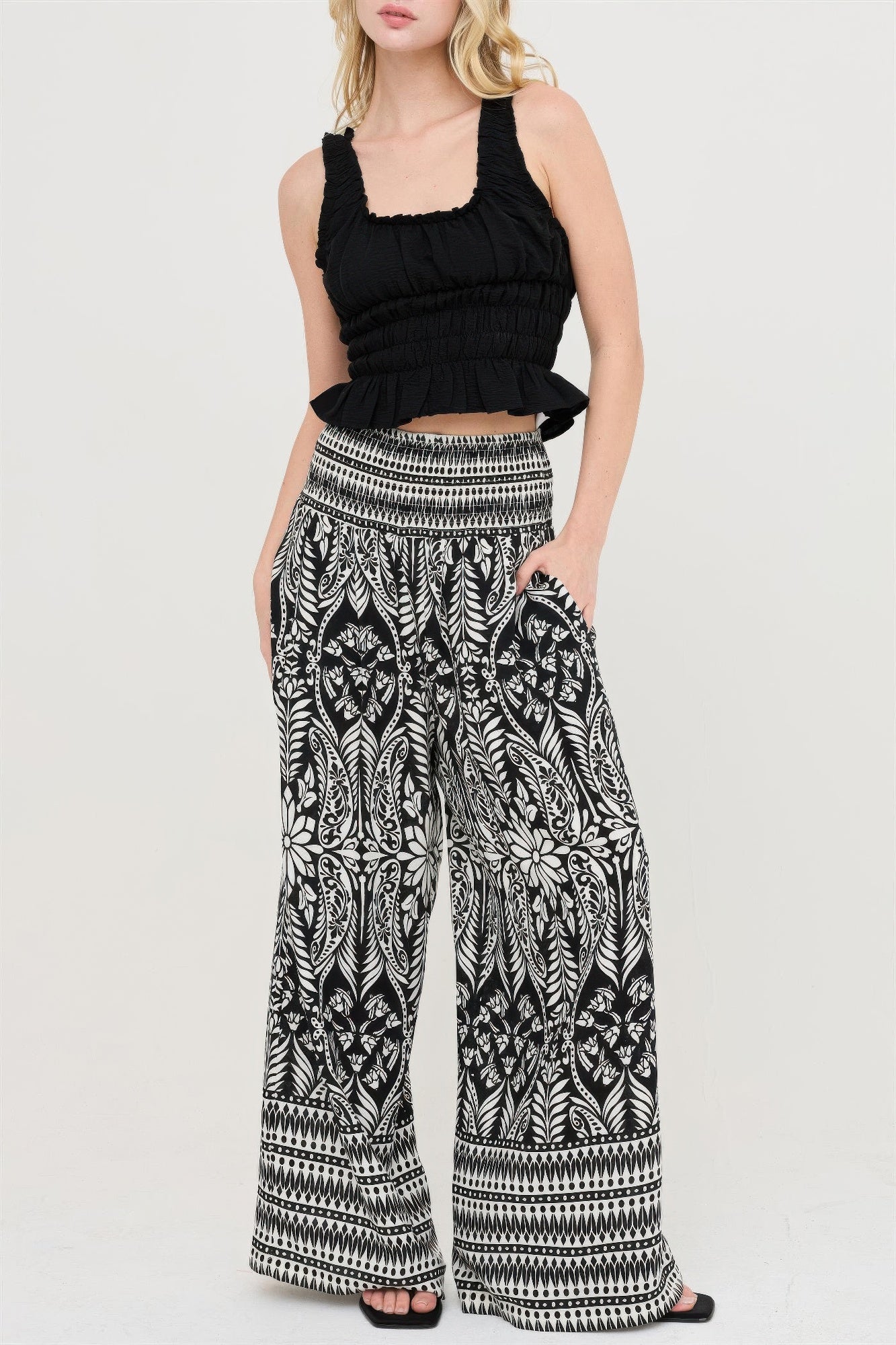 Black smocked waist floral pants, wide leg with detailed white leaf pattern
