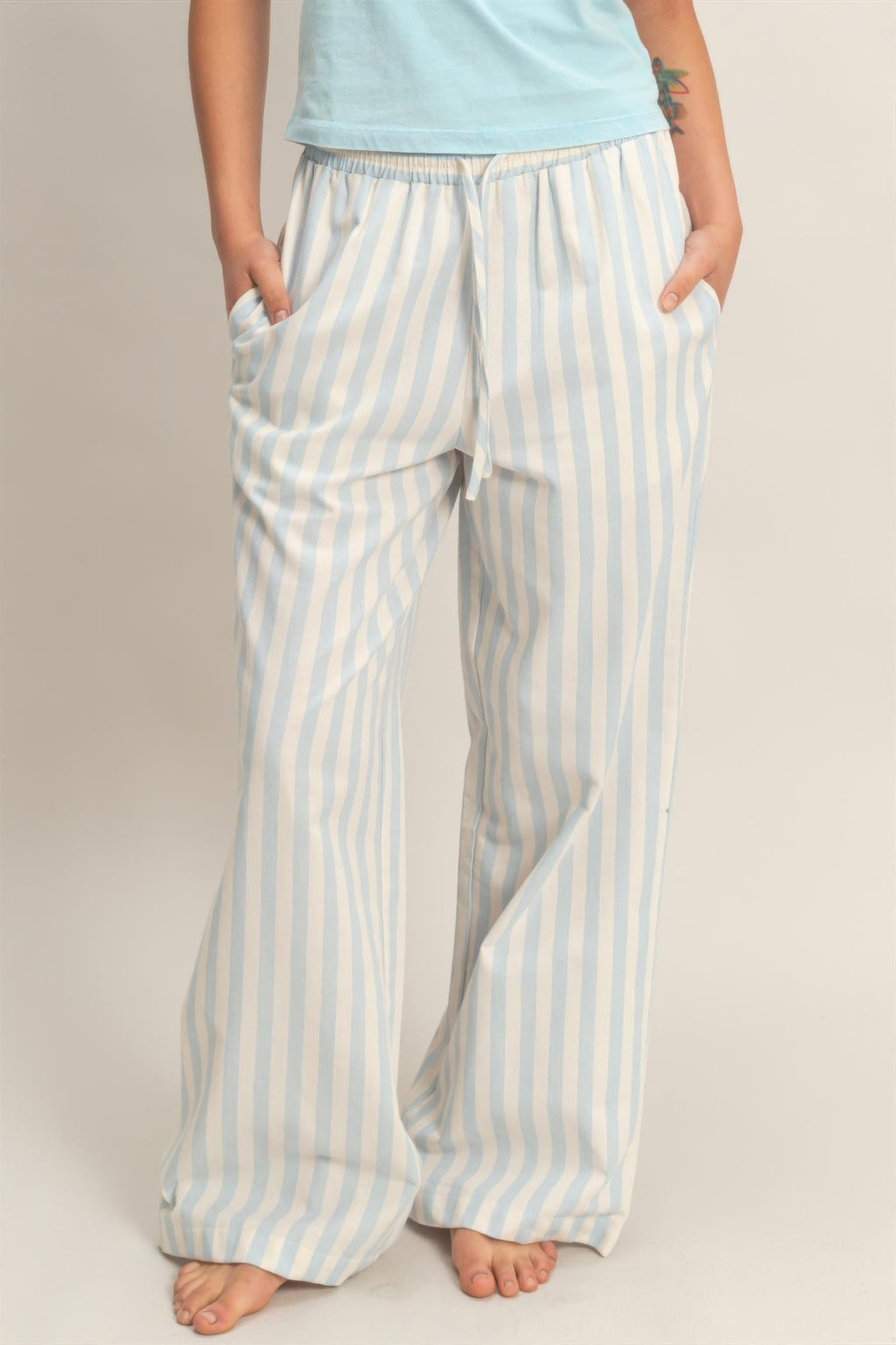 Light blue and white vertical striped elastic-waist pants with side pockets, full length