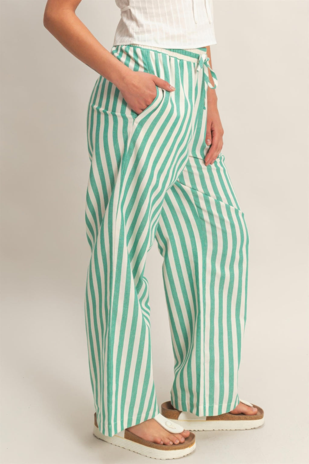 Green-and-white striped wide-leg pants with side pocket and tie waist detail