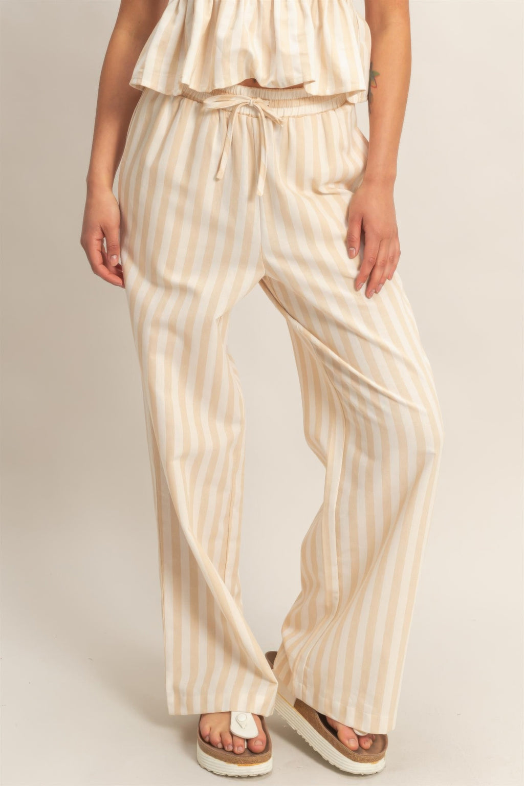 Vertical striped elastic pants with drawstring waist, side pockets, cream with tan stripes