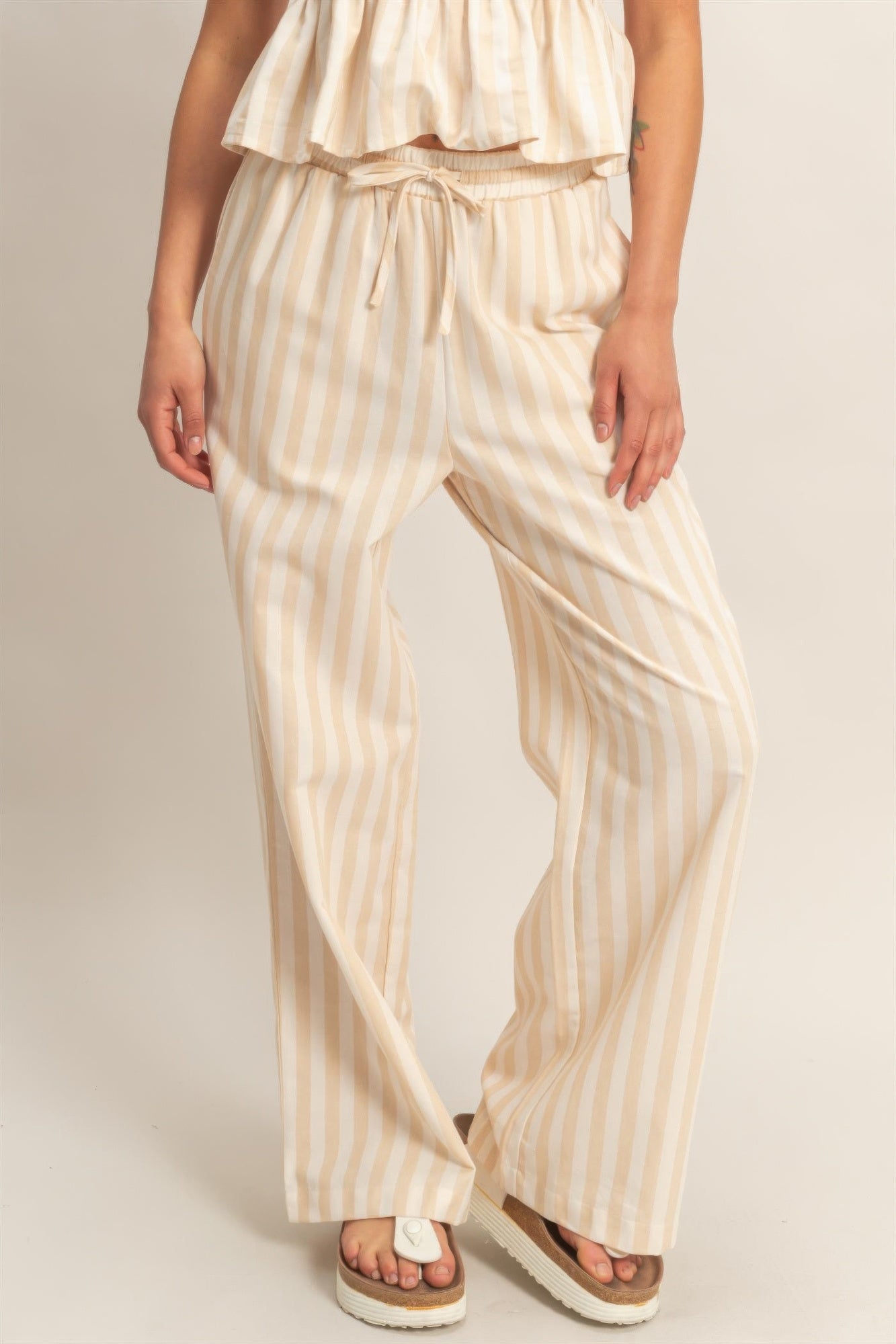 Vertical striped elastic pants with drawstring waist, side pockets, cream with tan stripes