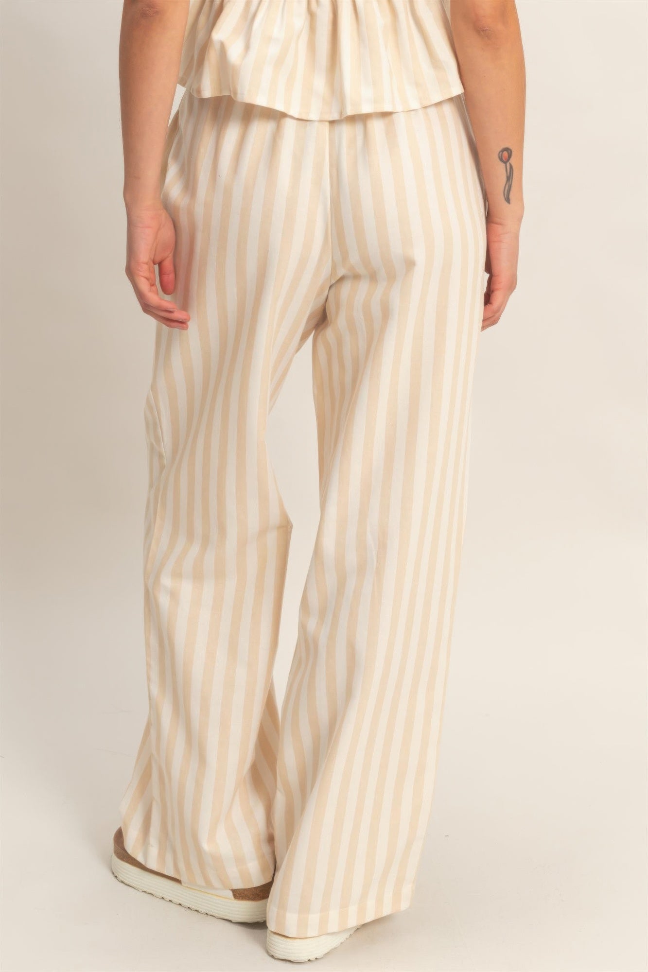 Cream/tan vertical striped wide-leg pants with side pockets and elastic waist