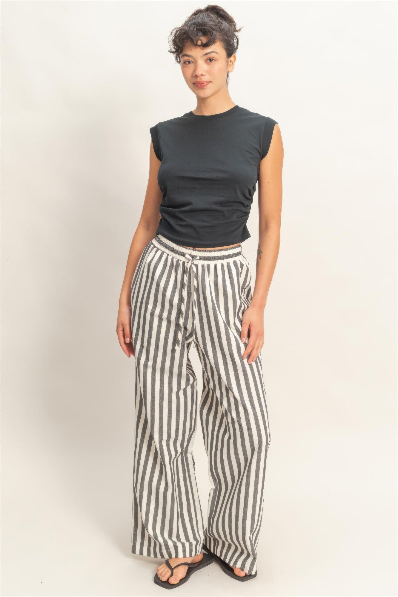 Black-and-white striped wide-leg pants with elastic waistband and side pockets