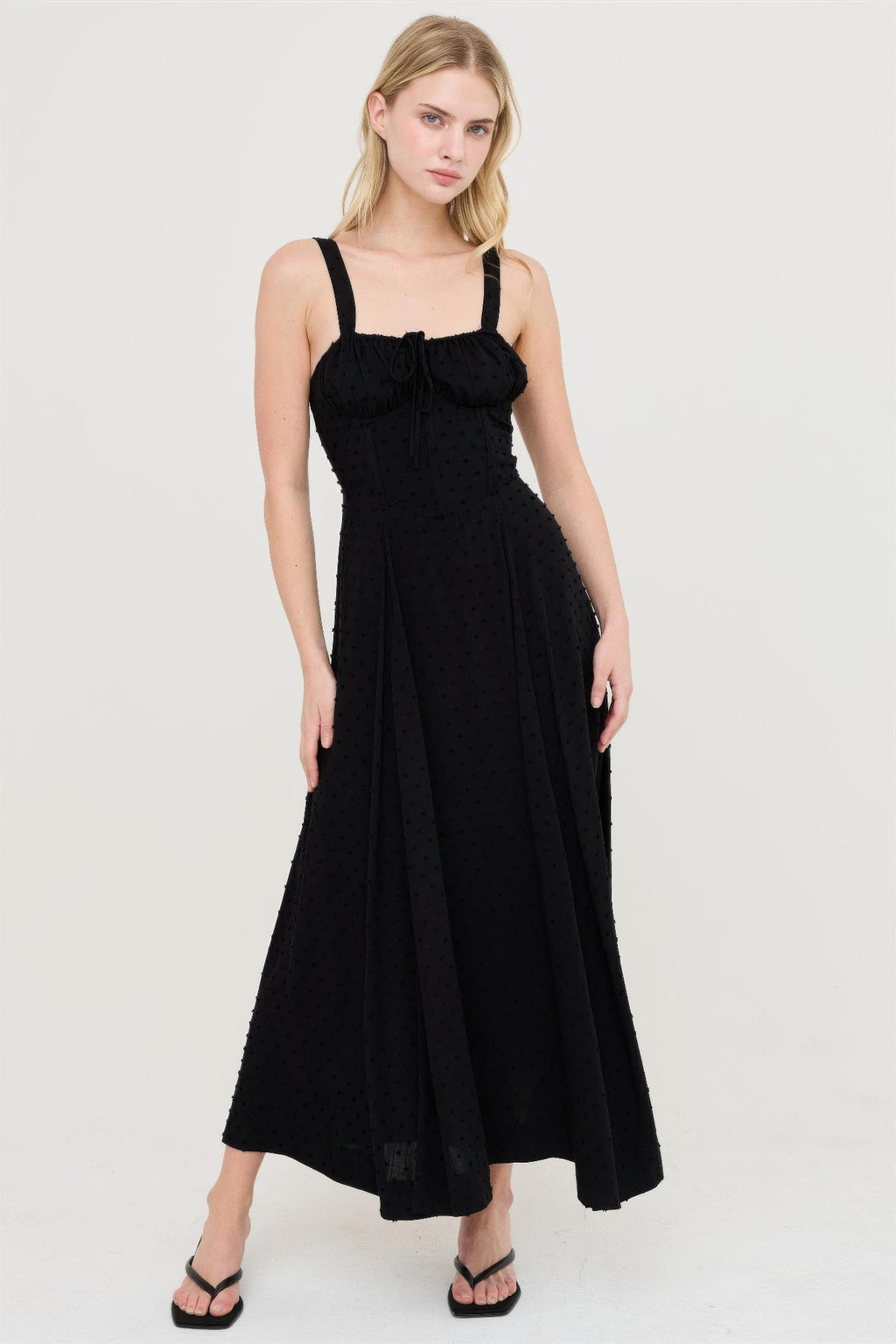 Black boned tie-back dress with dotted texture, ruched bust and midi flared skirt