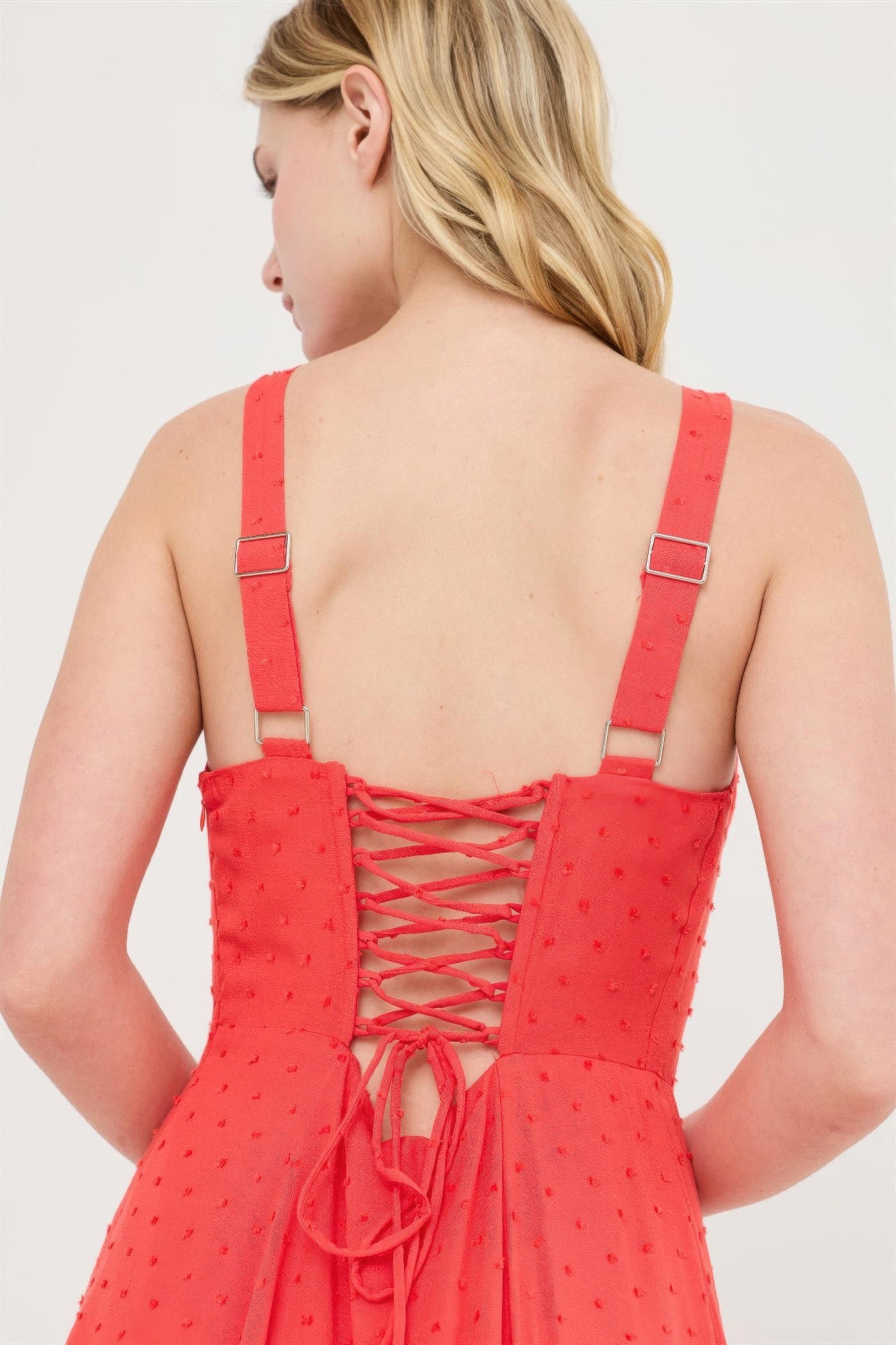 Back view: blood orange boned tie-back dress, crisscross lace-up and tie detail