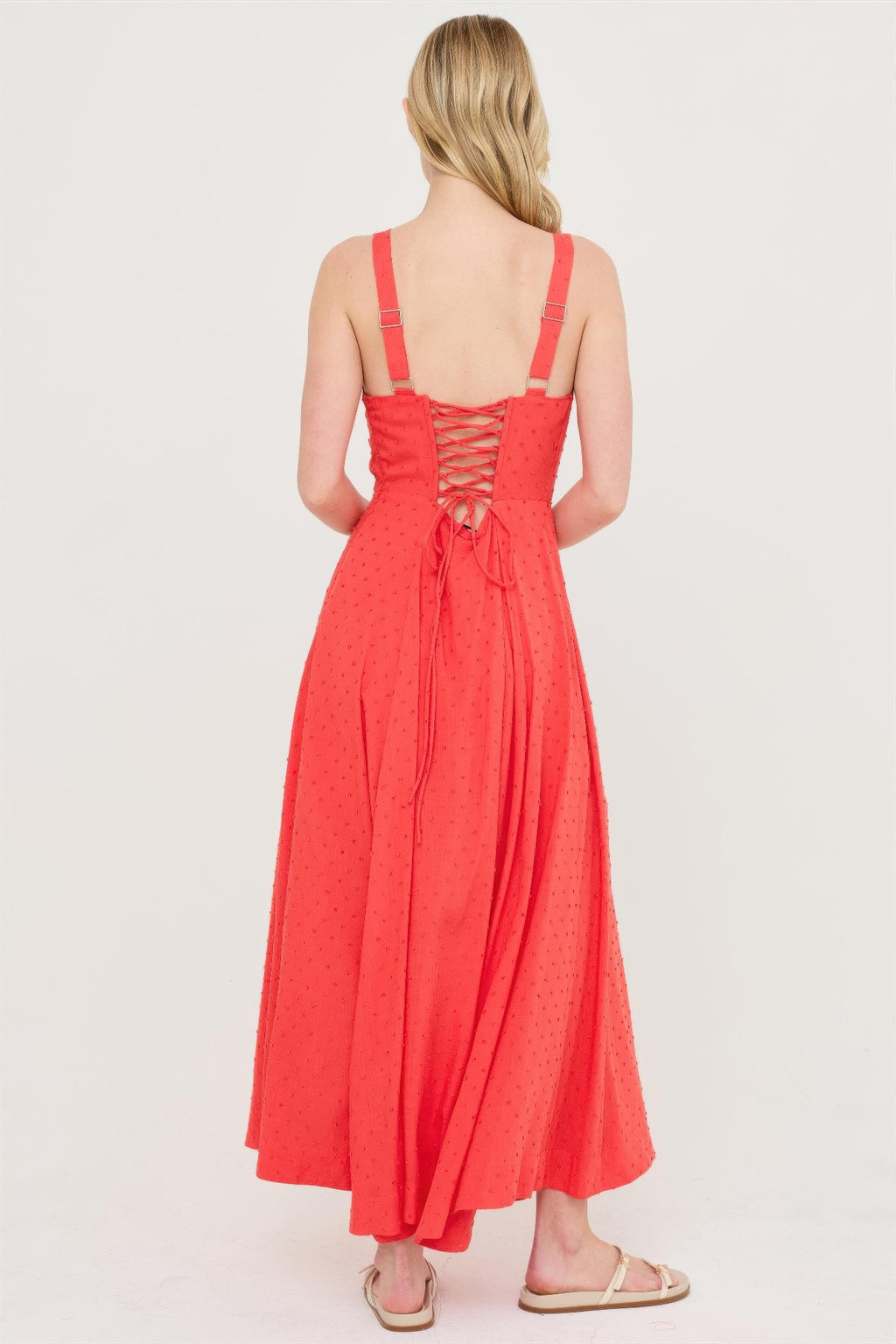Back view: blood orange boned tie-back dress, open crisscross back with bow tie