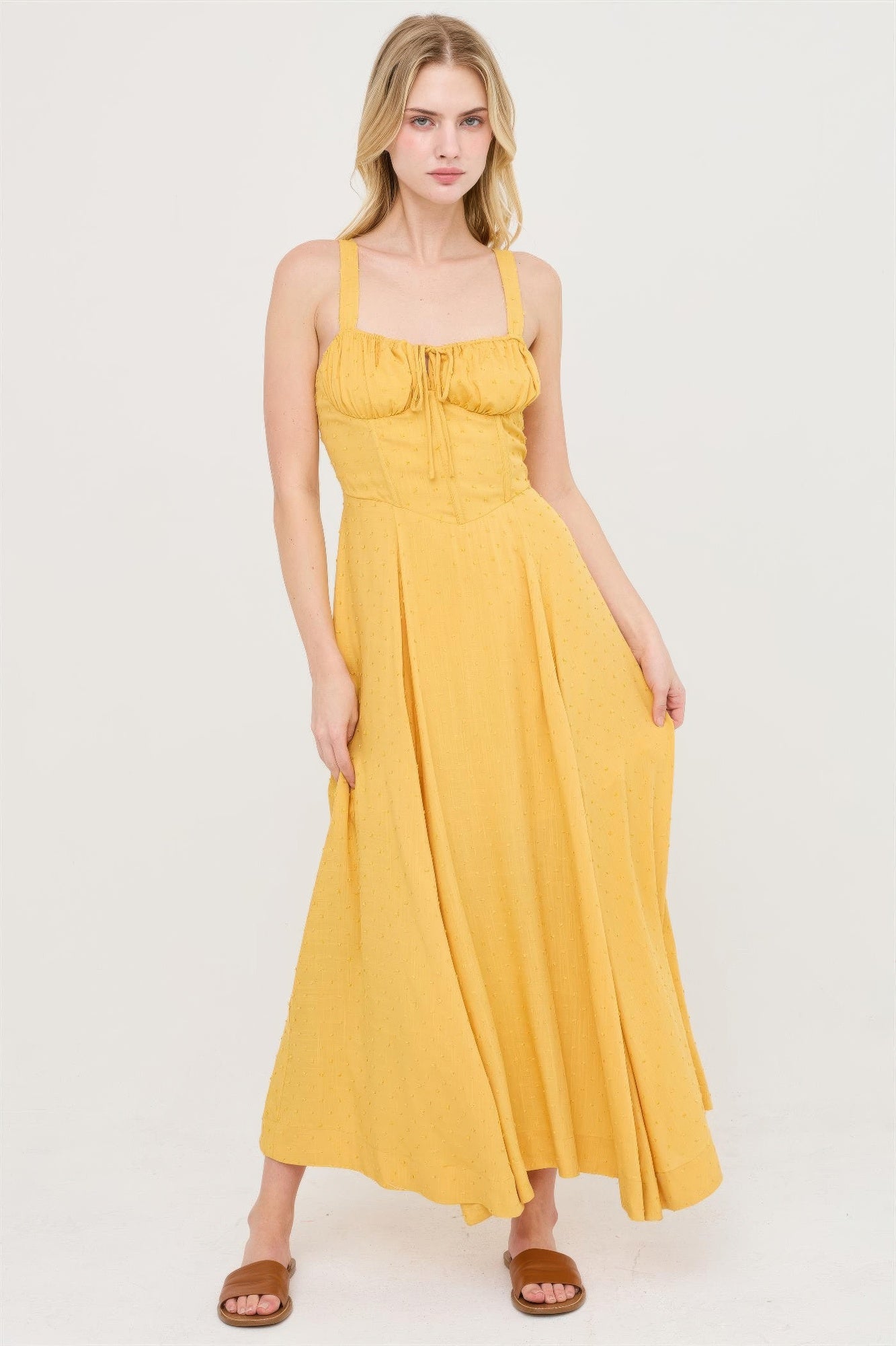 Mustard yellow tie-back midi dress with gathered bust and spaghetti straps.