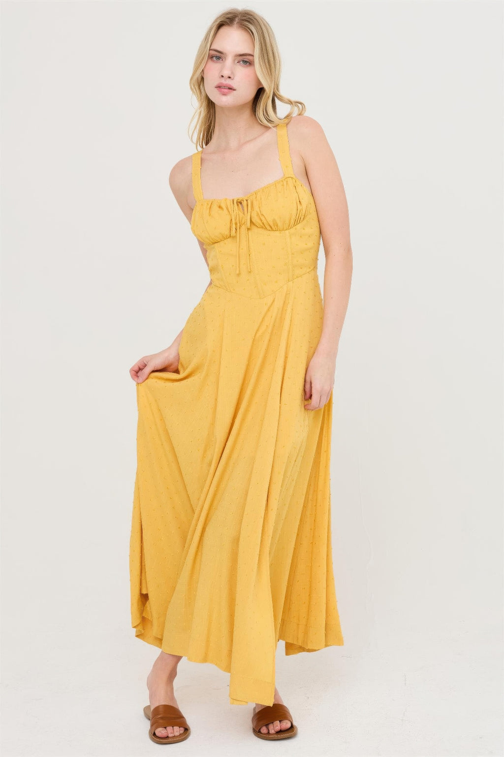 Mustard tie-back dress with draped skirt and soft pleats, spaghetti straps.
