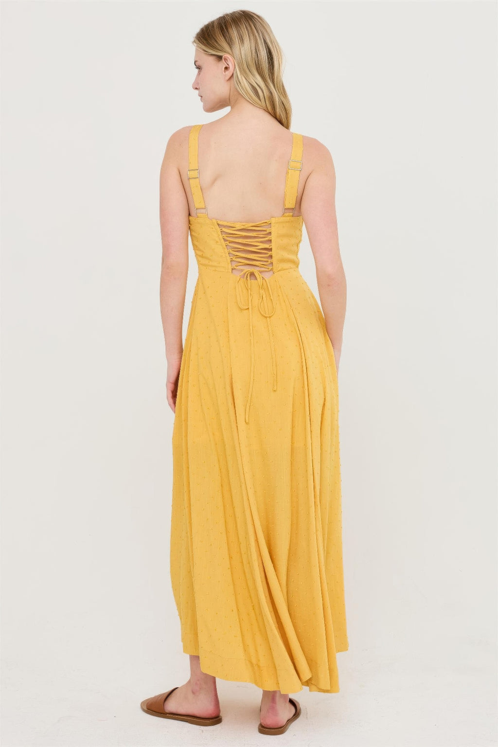 Mustard yellow tie-back midi dress from behind with adjustable shoulder straps.